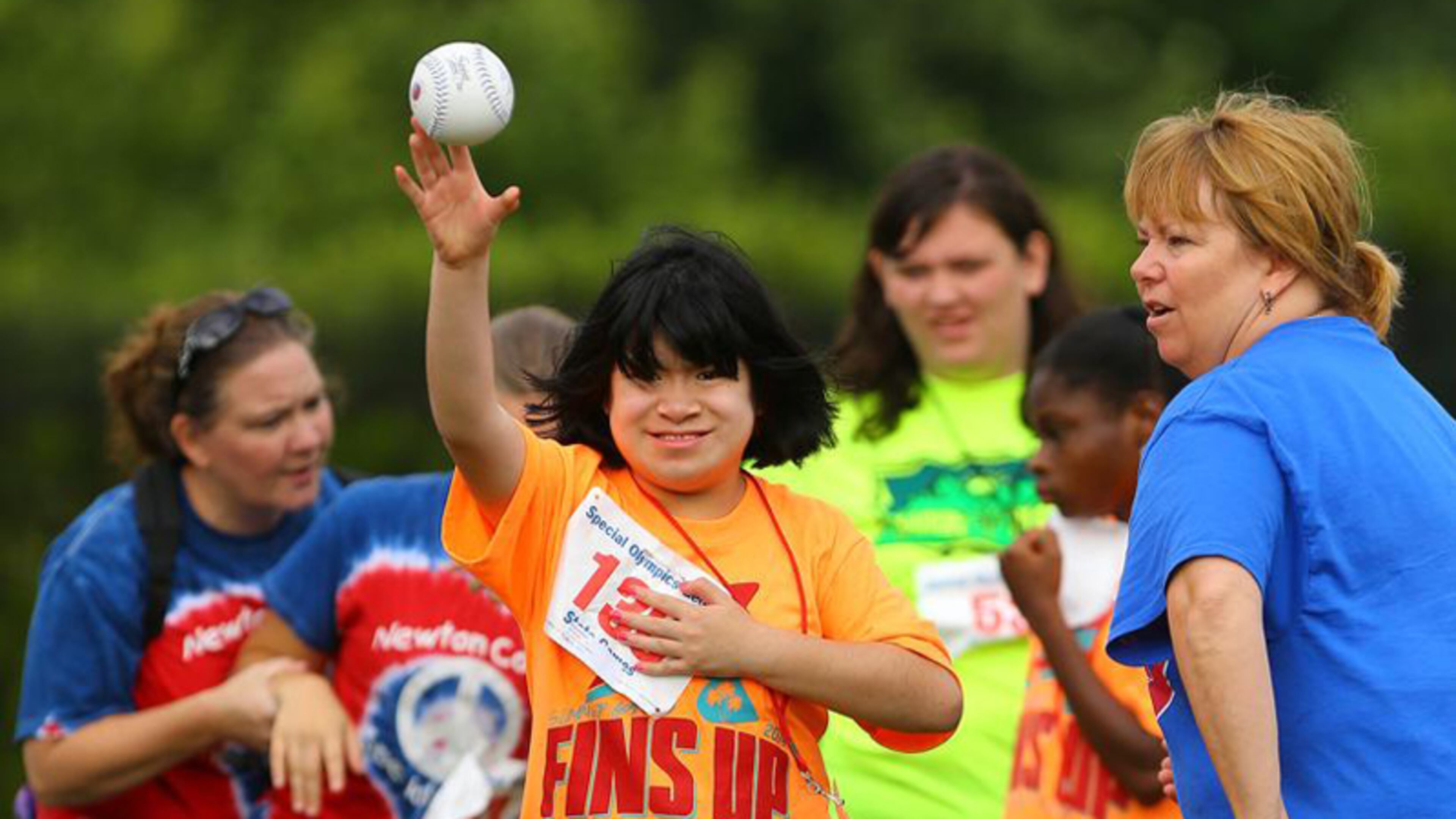 Kelsi Bollinger, 14, Fulton County Schools, makes her toss with a smile in the softball throw during the Georgia Special Olympics State Games. CURTIS COMPTON/AJC FILE