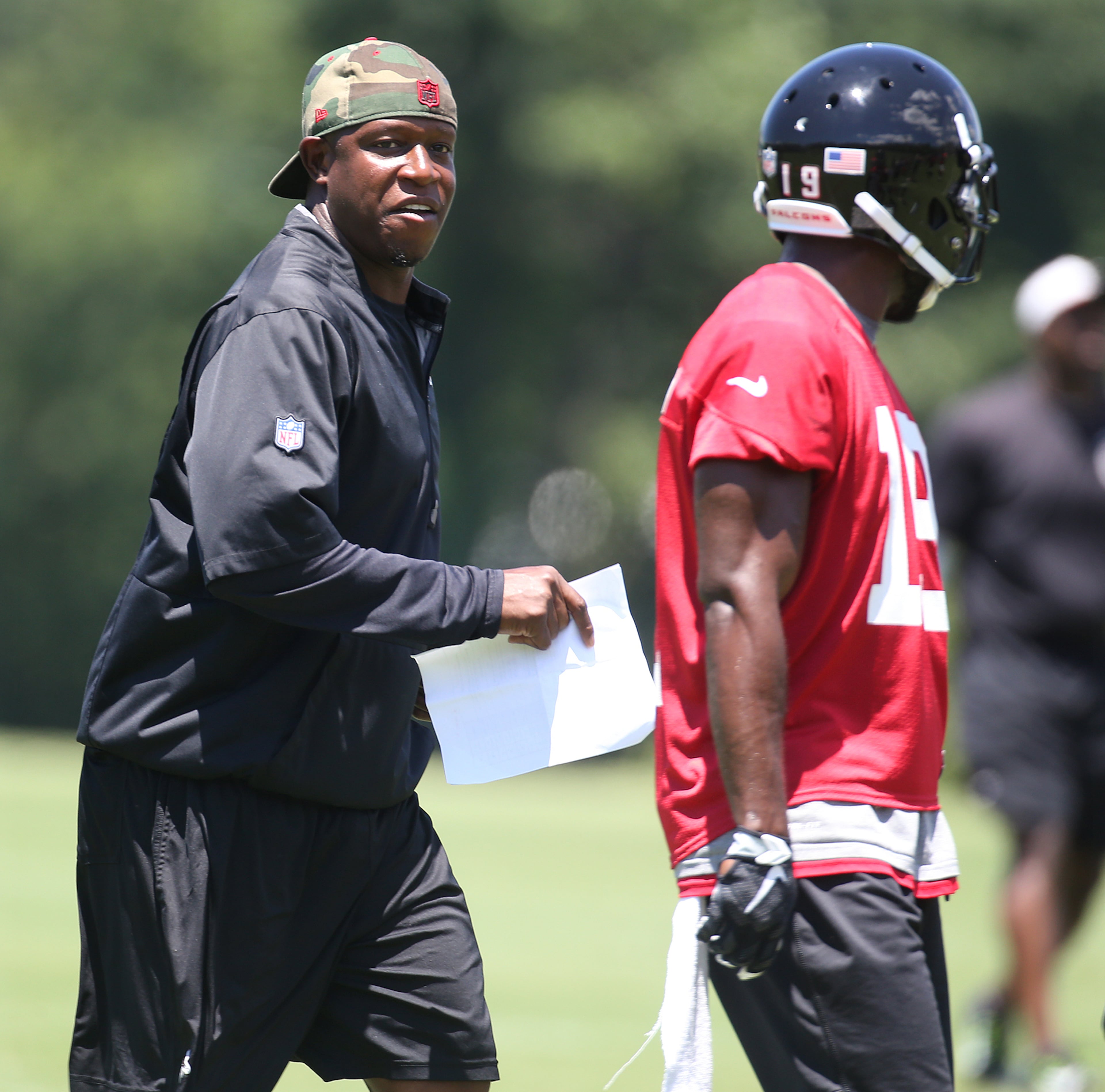 Falcons assistant head coach/wide receivers Raheem Morris chats up wide receiver Aldrick Robinson after a play during an OTA day on Tuesday, June 7, 2016, in Flowery Branch. Curtis Compton / ccompton@ajc.com