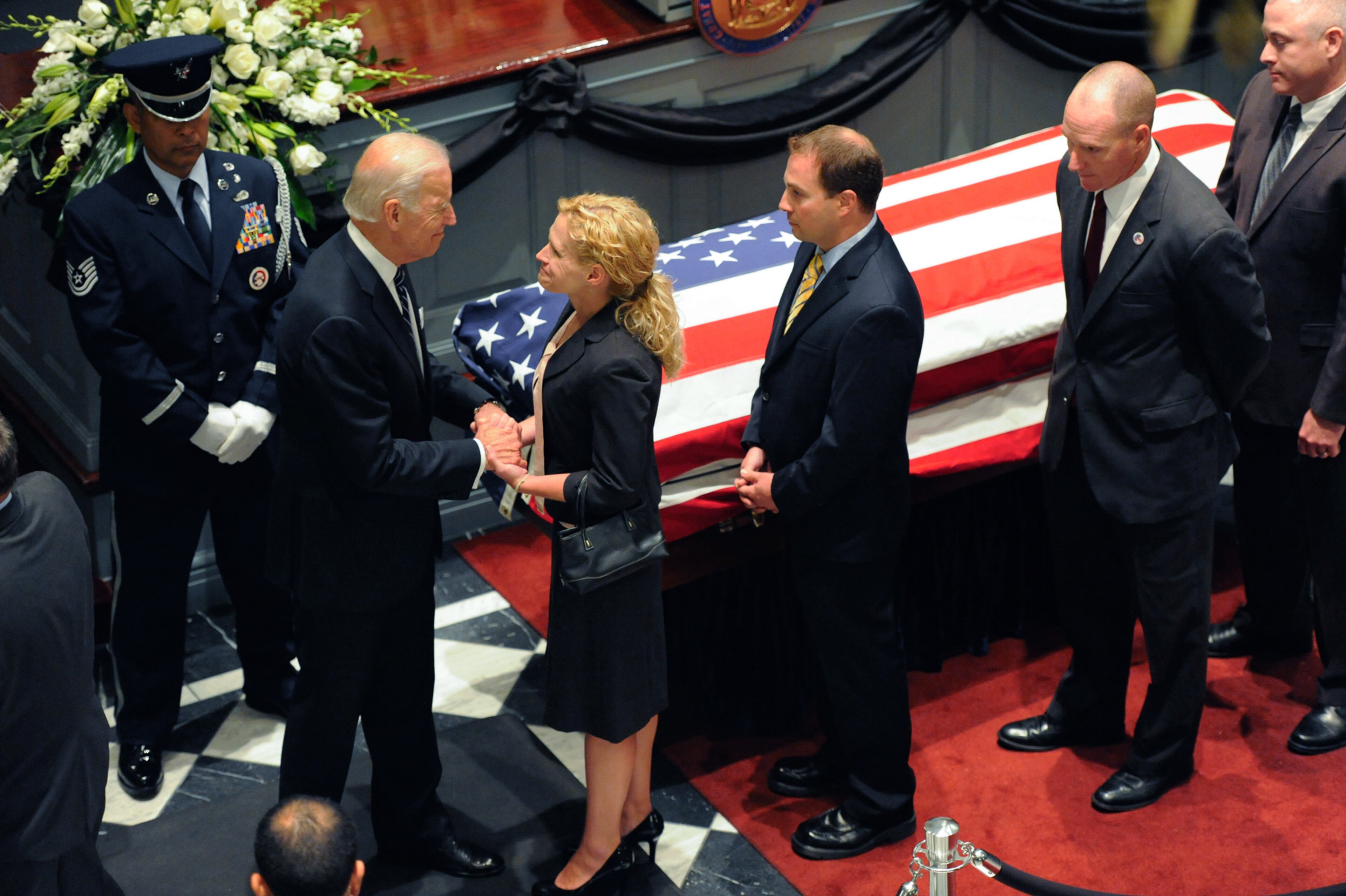 Vice President Joe Biden greets mourners near a casket containing the remains of Biden's son, former Delaware Attorney General Beau Biden, during a viewing, Thursday, June 4, 2015, at Legislative Hall in Dover, Del. Beau Biden died of brain cancer Saturday at age 46. (Jason Minto/The Wilmington News-Journal via AP)