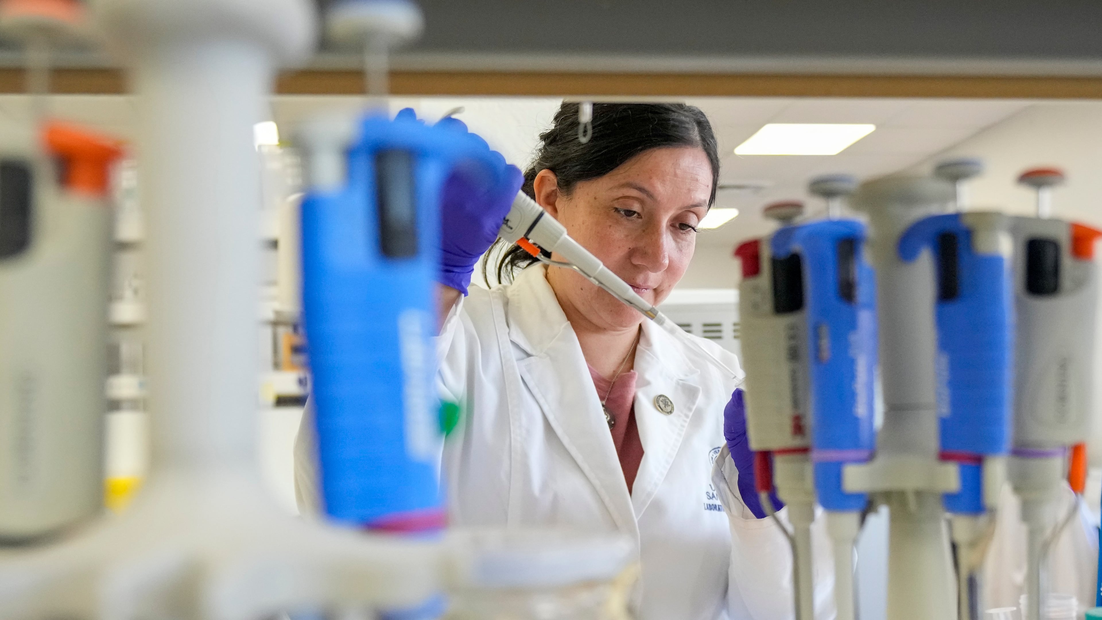 María Inés Barría, a virologist at the Universidad San Sebastián, works at the university, in Santiago, Chile, Wednesday, May 20, 2026. (AP Photo/Esteban Felix)