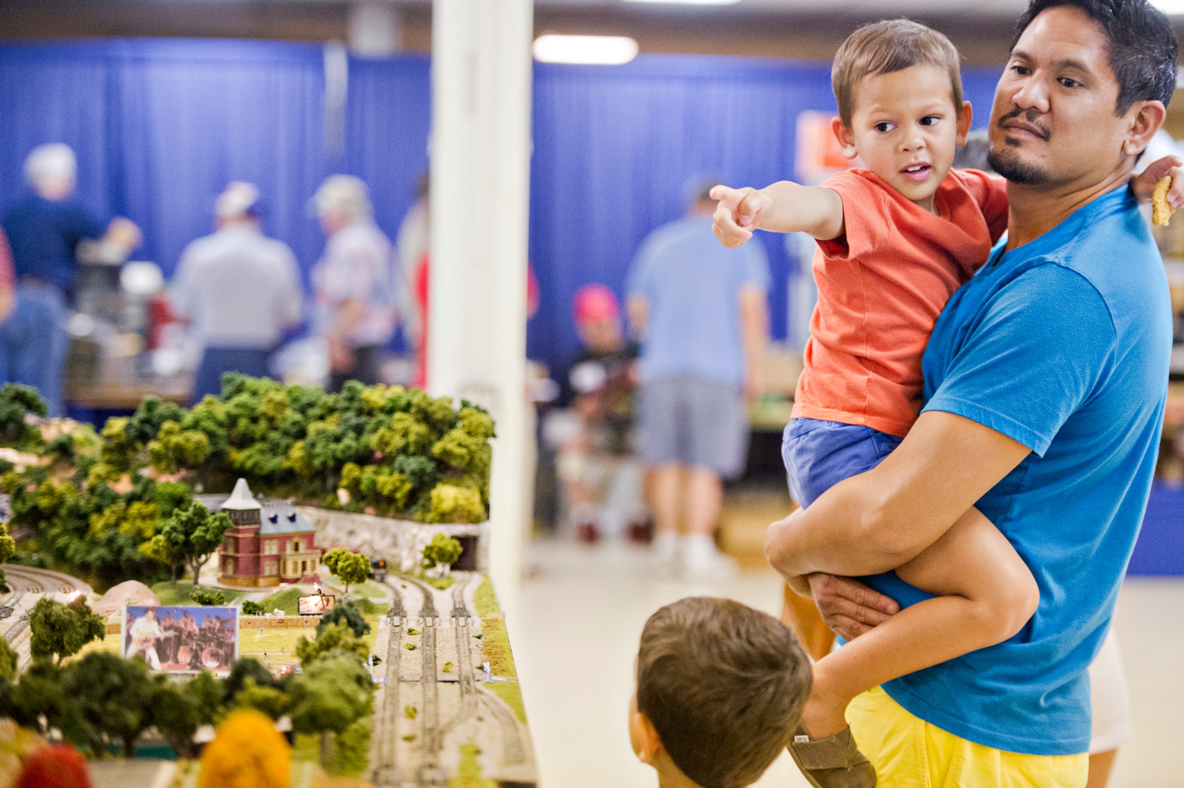 Phoenix Guerzon (left) is held by his father Michael as they watch model trains pass by during the 47th Atlanta Model Train and Railroadiana Show and Sale at the North Atlanta Trade Center in Norcross on Saturday, August 9, 2014. The show featured over 300 tables representing dealers from all over the nation showing railroad model items in all gauges as well as railroad antiques. JONATHAN PHILLIPS / SPECIAL