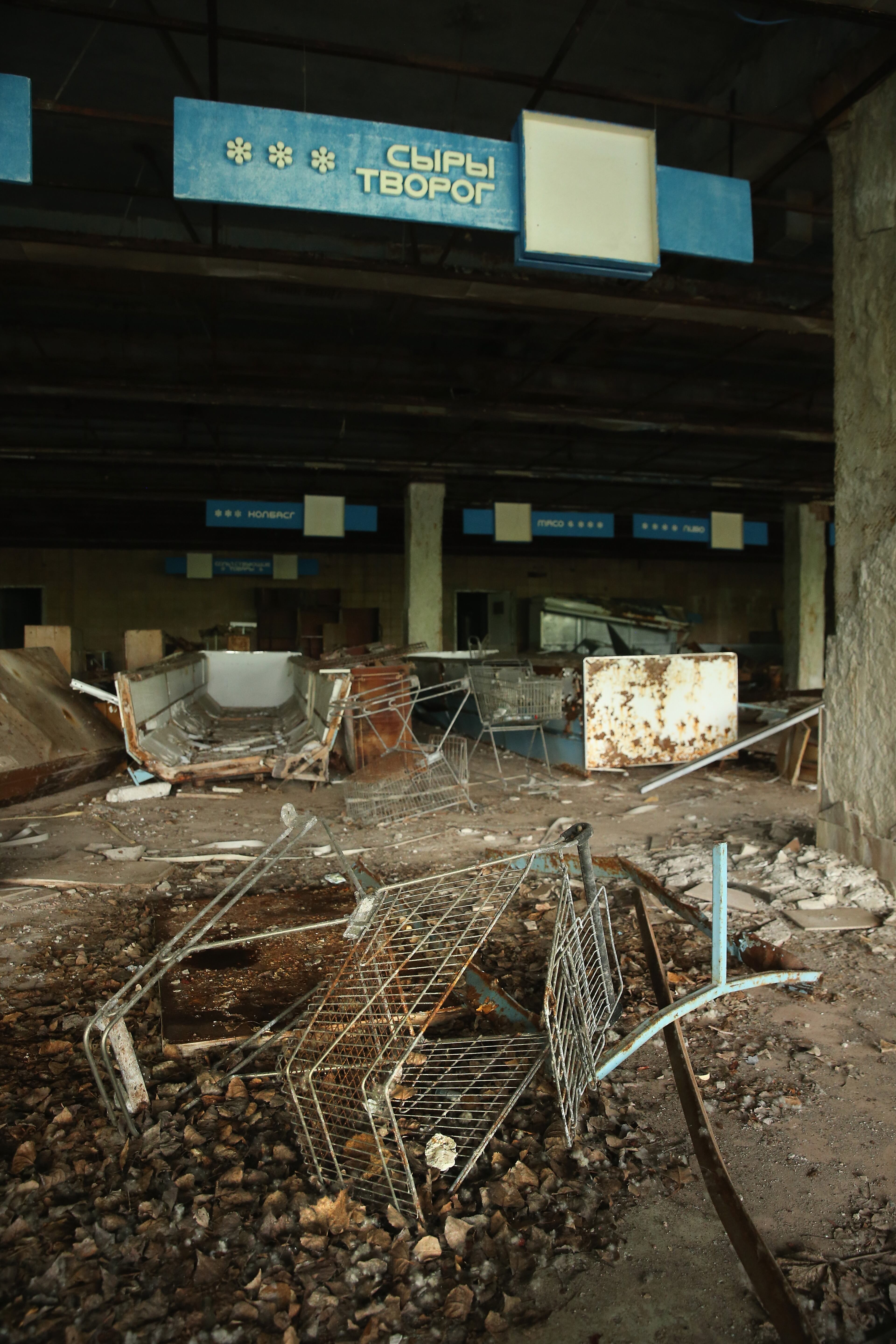 PRIPYAT, UKRAINE - SEPTEMBER 30: Rusting shopping carts and other debris litter the floor of an abandoned supermarket on September 30, 2015 in Pripyat, Ukraine. Pripyat lies only a few kilometers from the former Chernobyl nuclear power plant and was built in the 1970s to house the plant's workers and their families. On April 26, 1986, technicians at Chernobyl conducting a test inadvertently caused reactor number four to explode, sending plumes of highly radioactive particles and debris into the atmosphere. Authorities evacuated 120,000 people from the area, including 43,000 from Pripyat. Today Pripyat is a ghost-town, its apartment buildings, shops, restaurants, hospital, schools, cultural center and sports facilities derelict and its streets overgrown with trees. The city lies in the inner exclusion zone around Chernobyl where hot spots of persistently high levels of radiation make the area uninhabitable for thousands of years to come. (Photo by Sean Gallup/Getty Images)