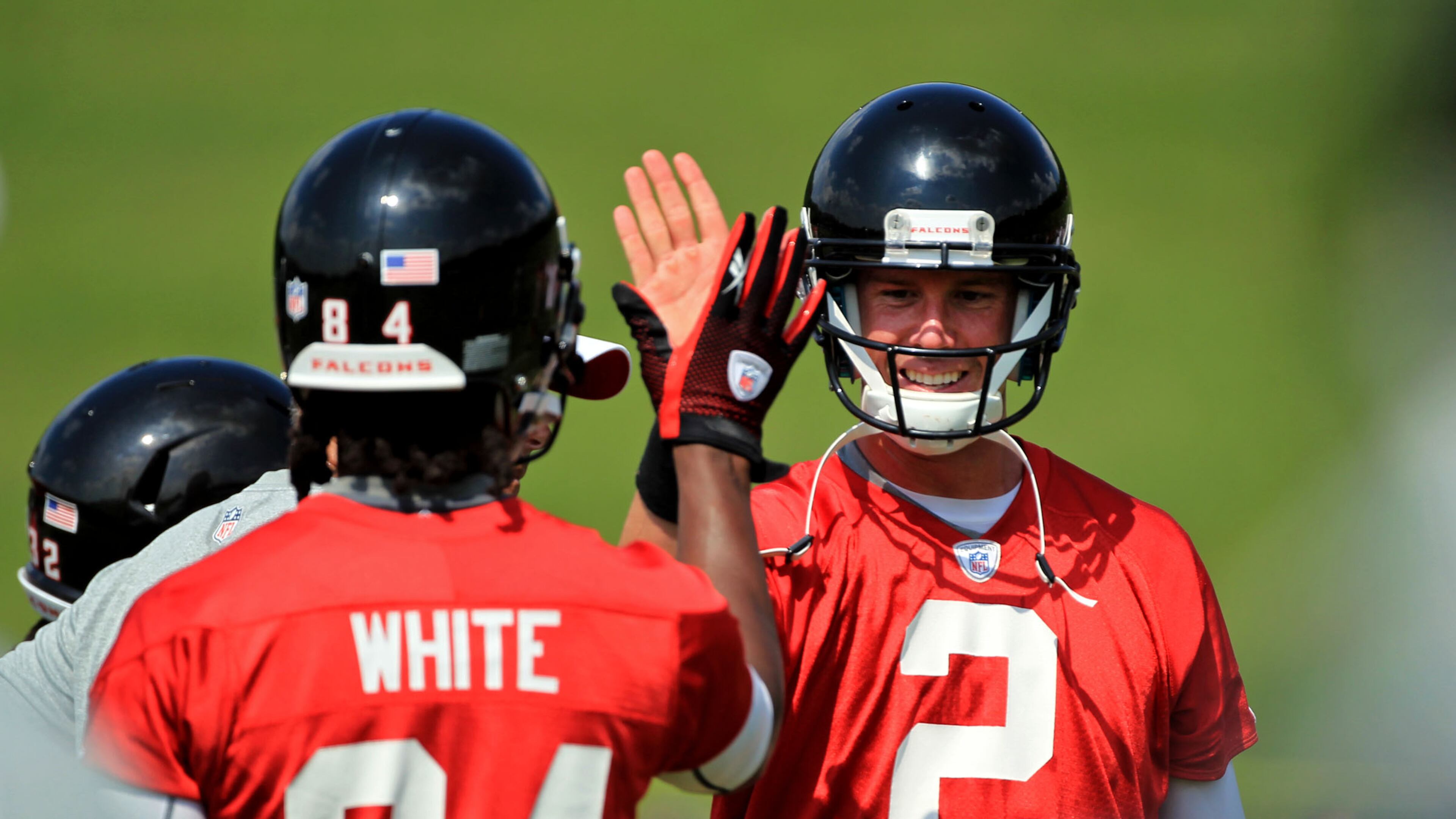 Roddy White (left) and Matt Ryan enjoy a play at minicamp in 2012. JASON GETZ / JGETZ@AJC.COM