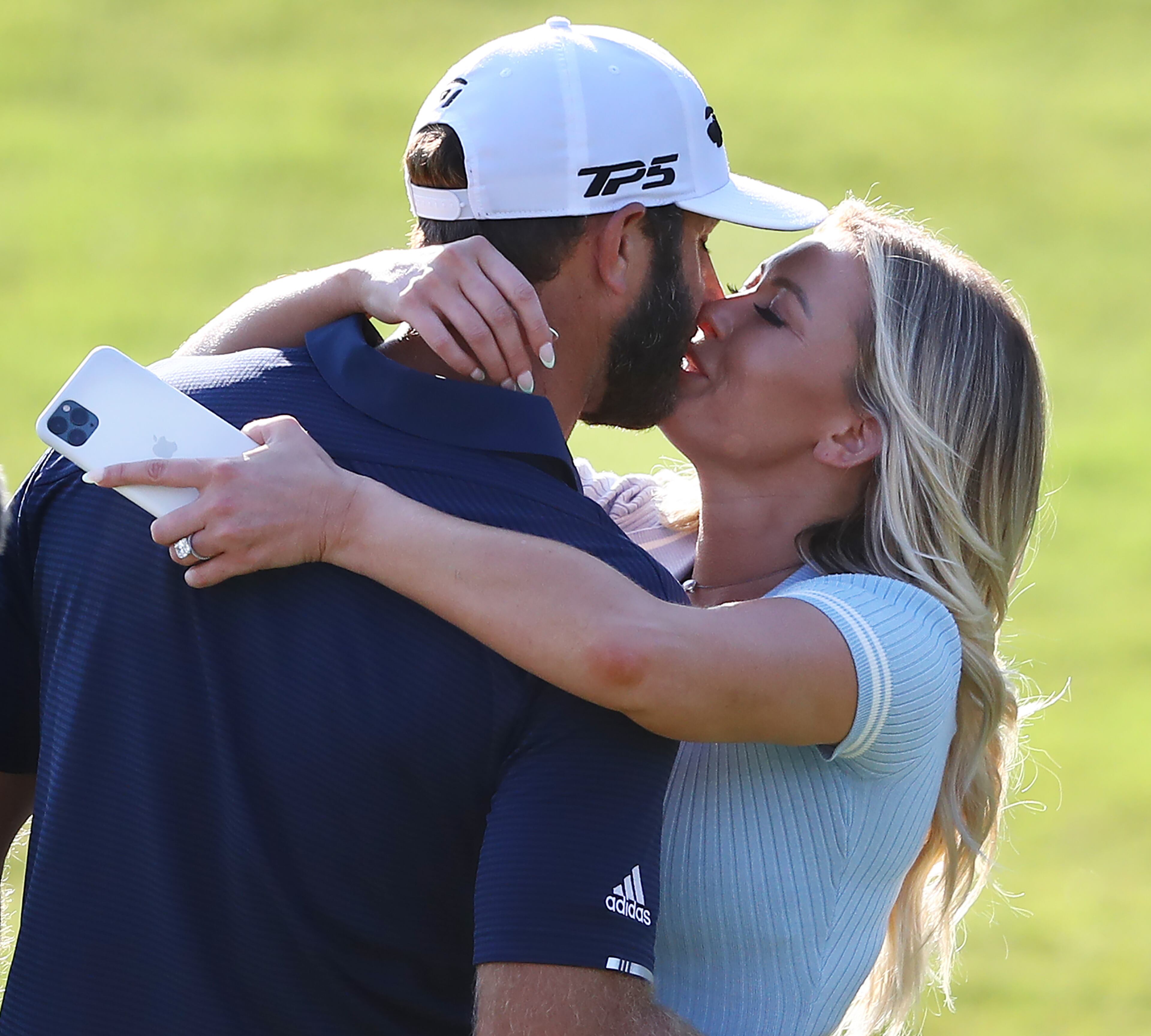 Dustin Johnson gets a kiss from his girlfriend Paulina Gretzky after sinking his birdie putt on the 18th green to win the Tour Championship and FedEx Cup by three strokes at 21 under par at East Lake Golf Club on Monday, Sept. 7, 2020 in Atlanta. Curtis Compton / Curtis.Compton@ajc.com