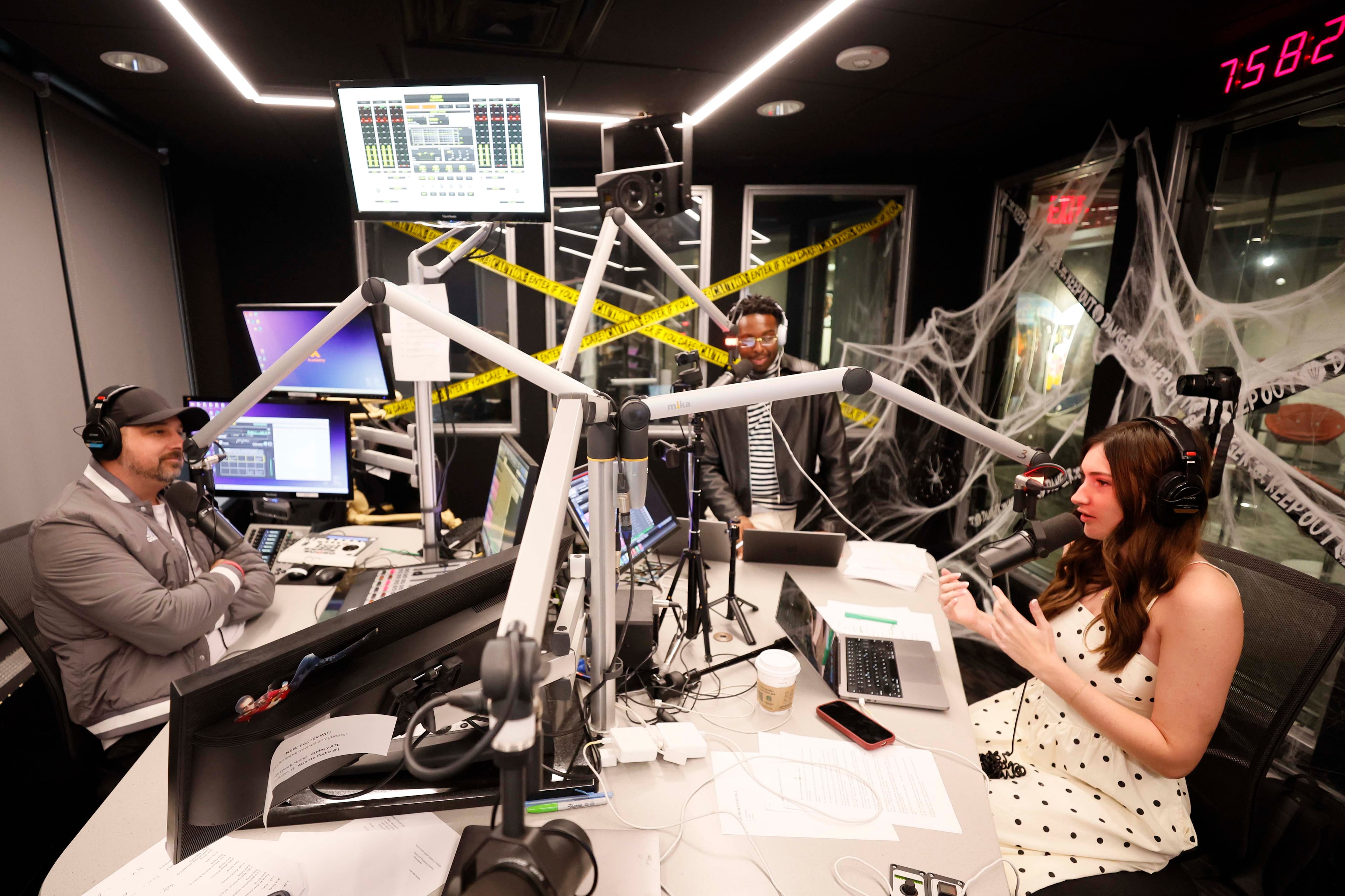 Co-host Anna “AB” Bohlmann speaks during “The Bret Mega Morning Show” with Bret Mega (left) and producer and co-host Chris Smith at Star 94. (Miguel Martinez/AJC)