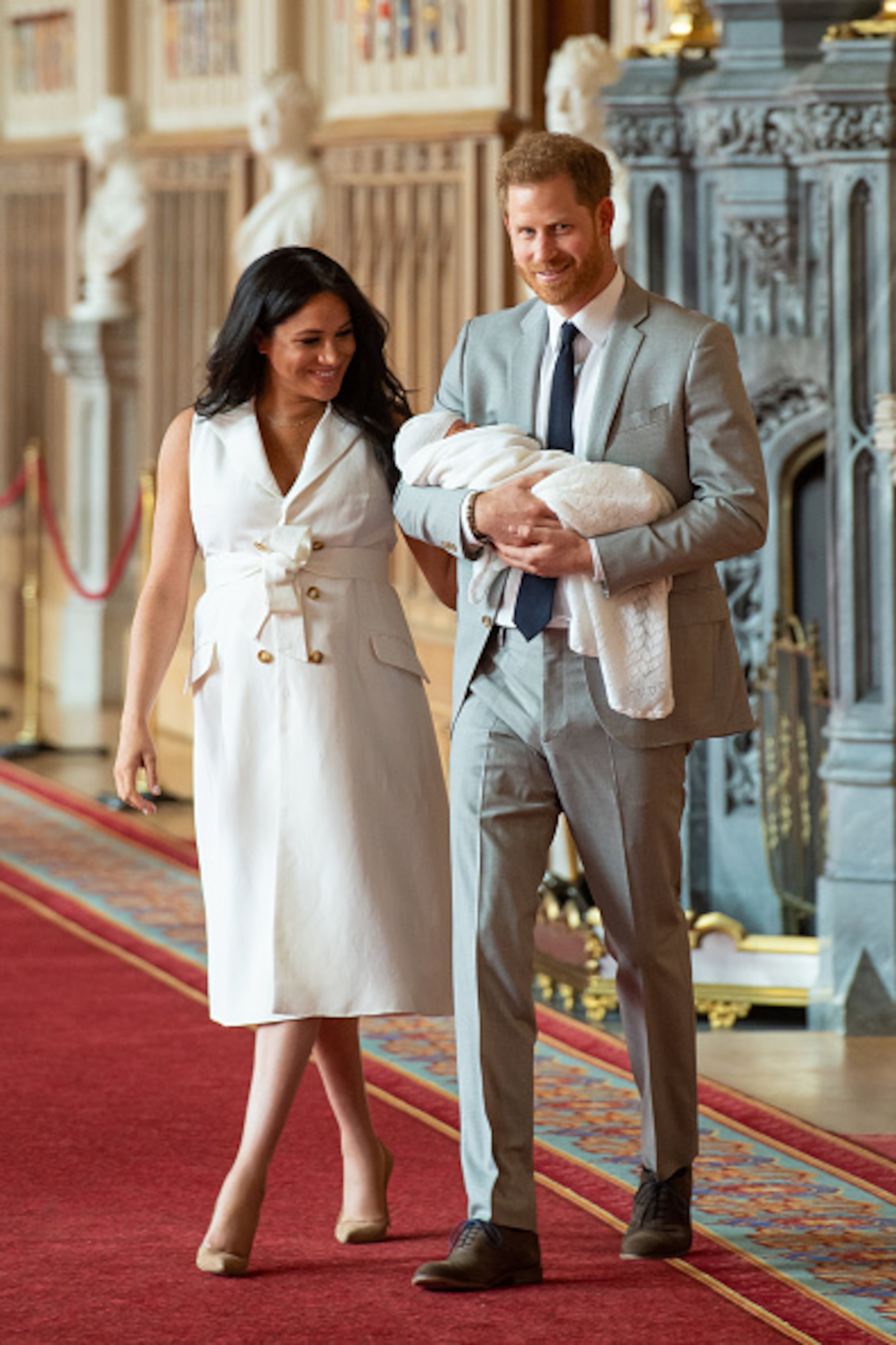 Prince Harry, Duke of Sussex and Meghan, Duchess of Sussex, pose with their newborn son during a photocall in St George's Hall at Windsor Castle on May 8, 2019 in Windsor, England. The Duchess of Sussex gave birth at 05:26 on Monday 06 May, 2019.