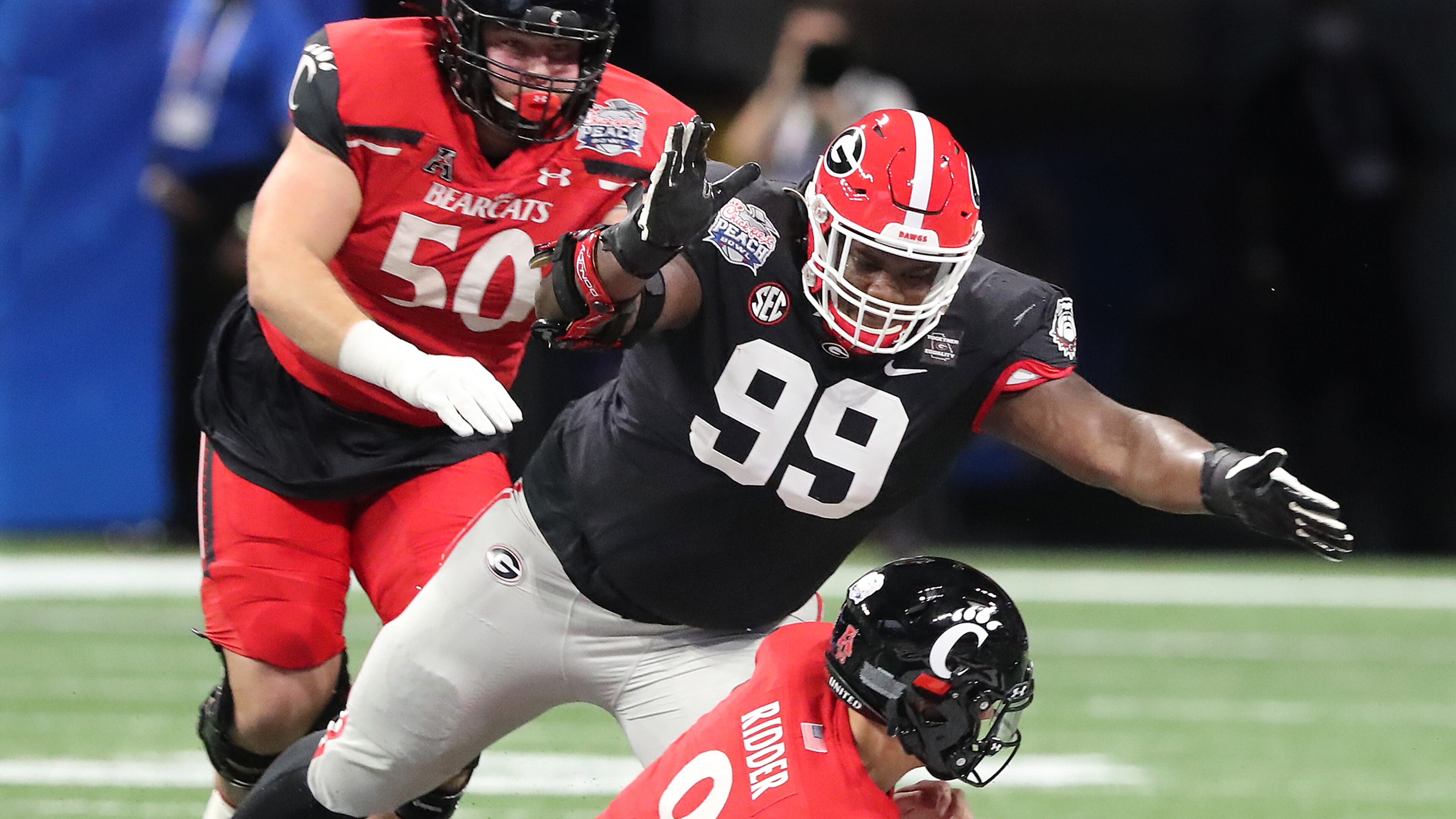 Georgia defensive lineman Jordan Davis smothers Cincinnati quarterback Desmond Ridder for a sack during the first half. Curtis Compton / Curtis.Compton@ajc.com”