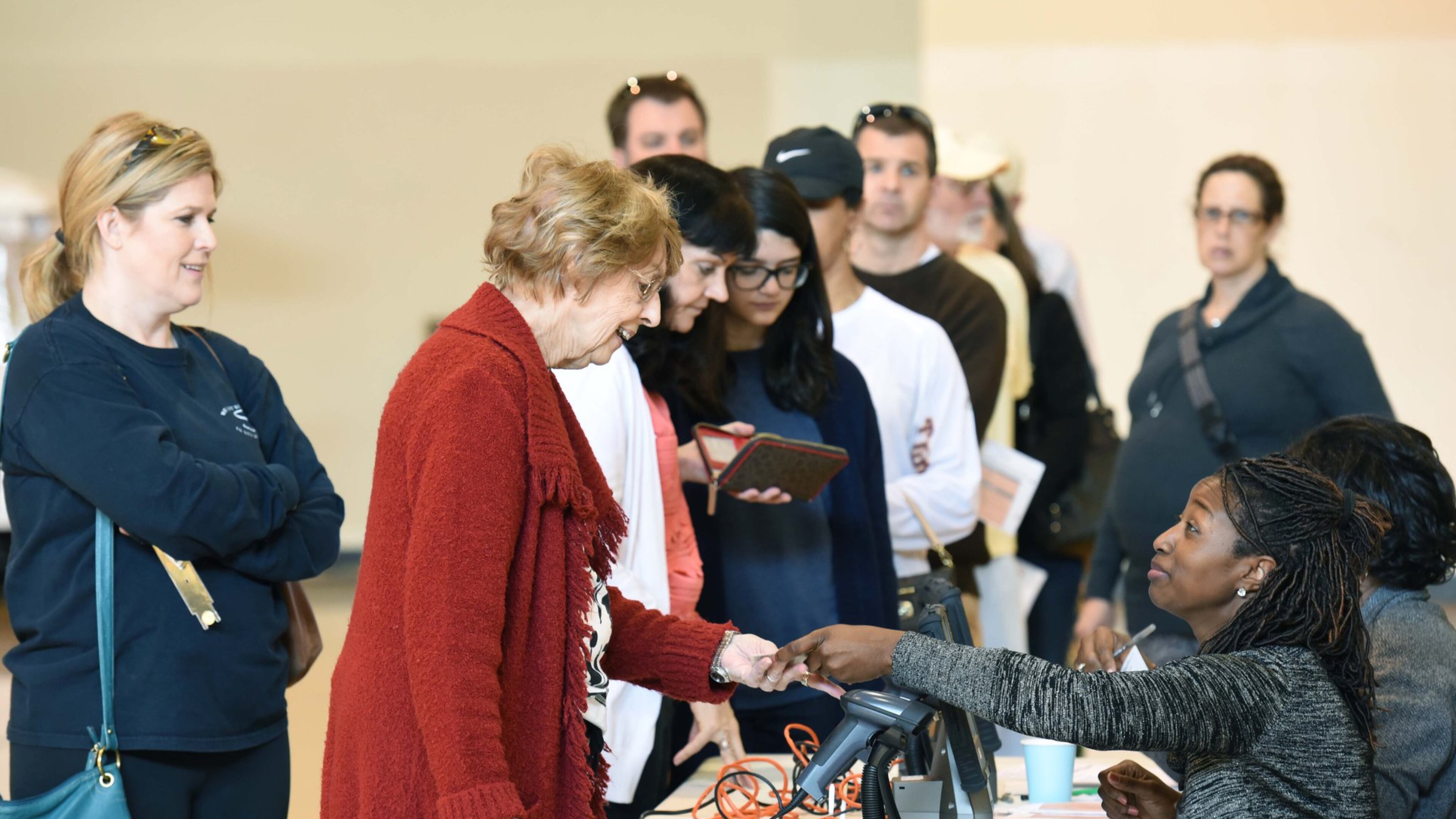 Catrice Crawford (right), a poll worker, helps LeAnn Strom as her daughter Trina Sims (left) looks at The Ministry Center of First Baptist Church of Tucker on Tuesday. Tucker residents were electing their first mayor and city council members as the historic community prepares to become a full-fledged city. Tucker is the eighth new city formed in metro Atlanta over the last decade. HYOSUB SHIN / HSHIN@AJC.COM