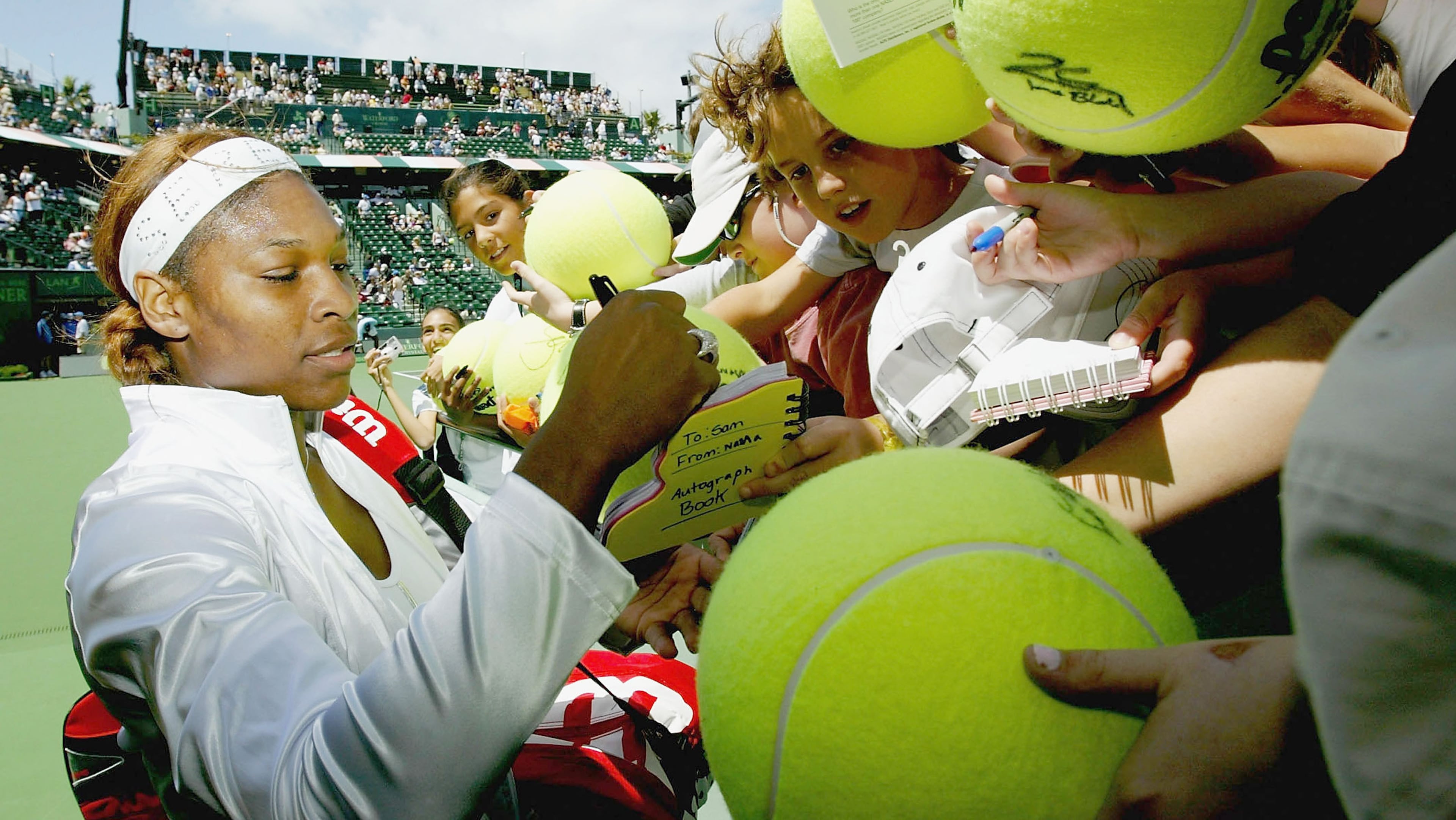 MIAMI, FL - MARCH 26: Serena Williams signs autographs after her match against Marta Marrero of Spain during the Nasdaq-100 Open, March 26, 2004, at the Crandon Park Tennis Center on Key Biscayne in Miami, Florida. (Photo by Ezra Shaw/Getty Images) *** Local Caption *** Serena Williams