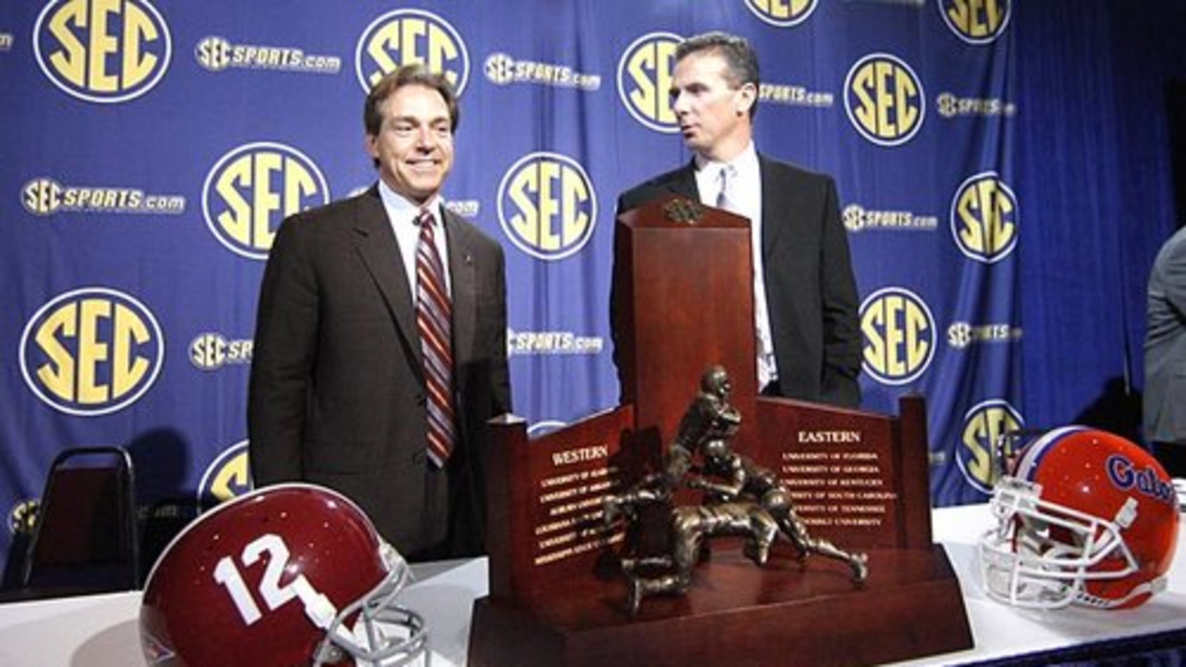 Alabama coach Nick Saban, left, and Florida coach Urban Meyer stand in front of the SEC trophy Friday.