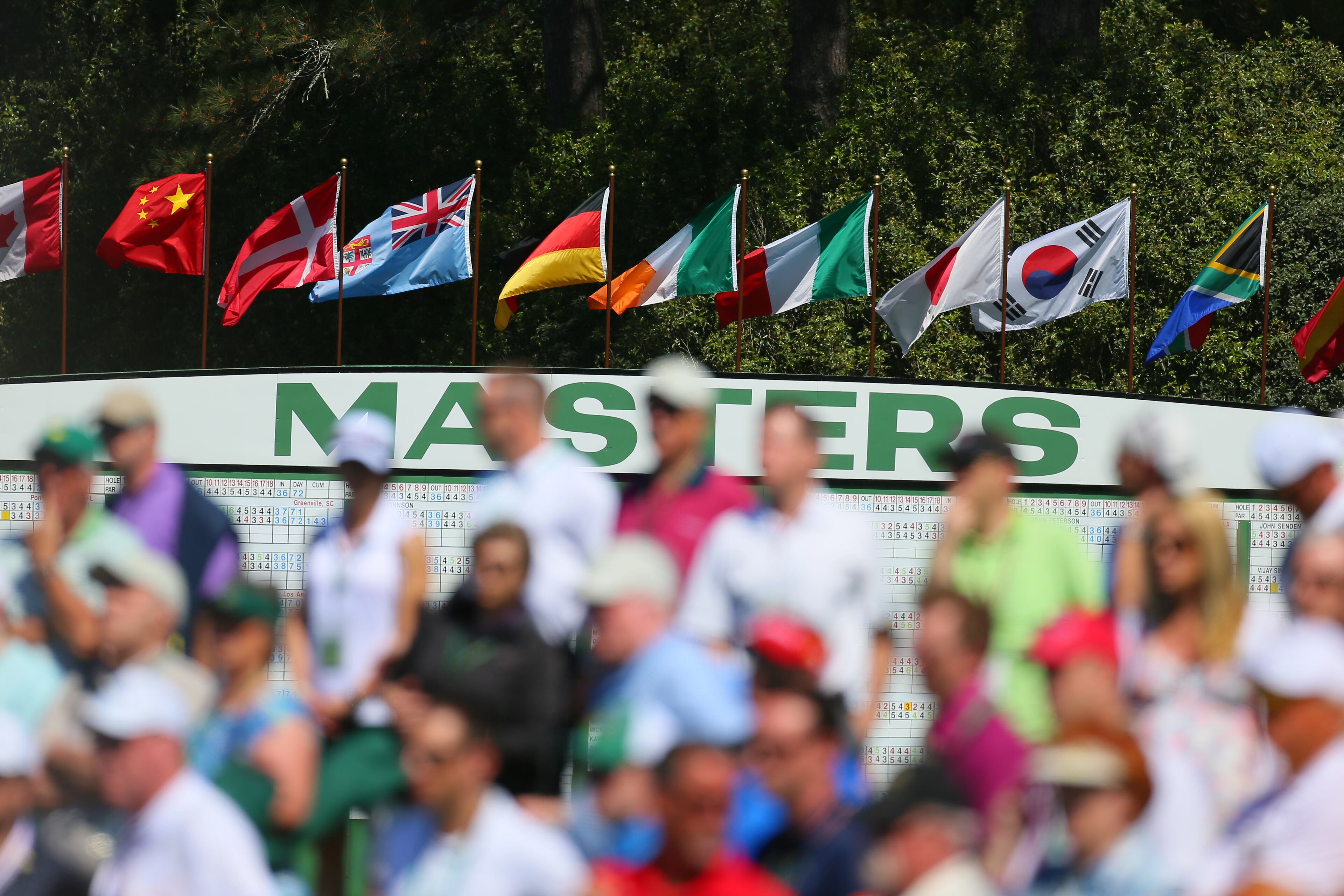 Fans shown in front of the Masters scoreboard during the third round in the Masters Tournament at Augusta National Golf Club on Saturday April 13 2013.