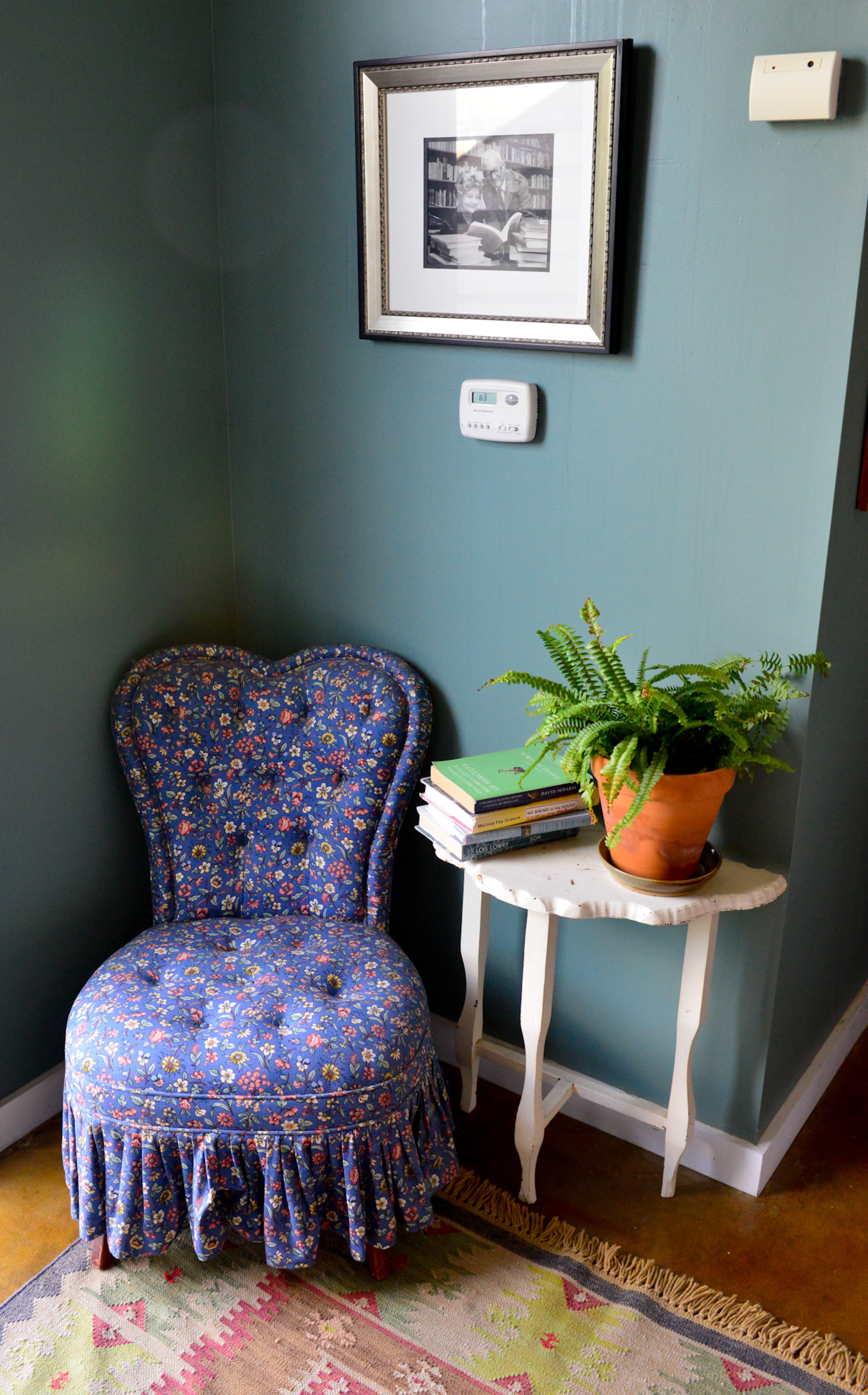 A sweetheart chair has been passed down from loft owner Betsy Walsh's mother, whose parents gave it to her when she was 16, to Betsy's daughter. The chair is paired with other treasures, including a wooden table made by another family member and a photo of Thomas' grandparents.