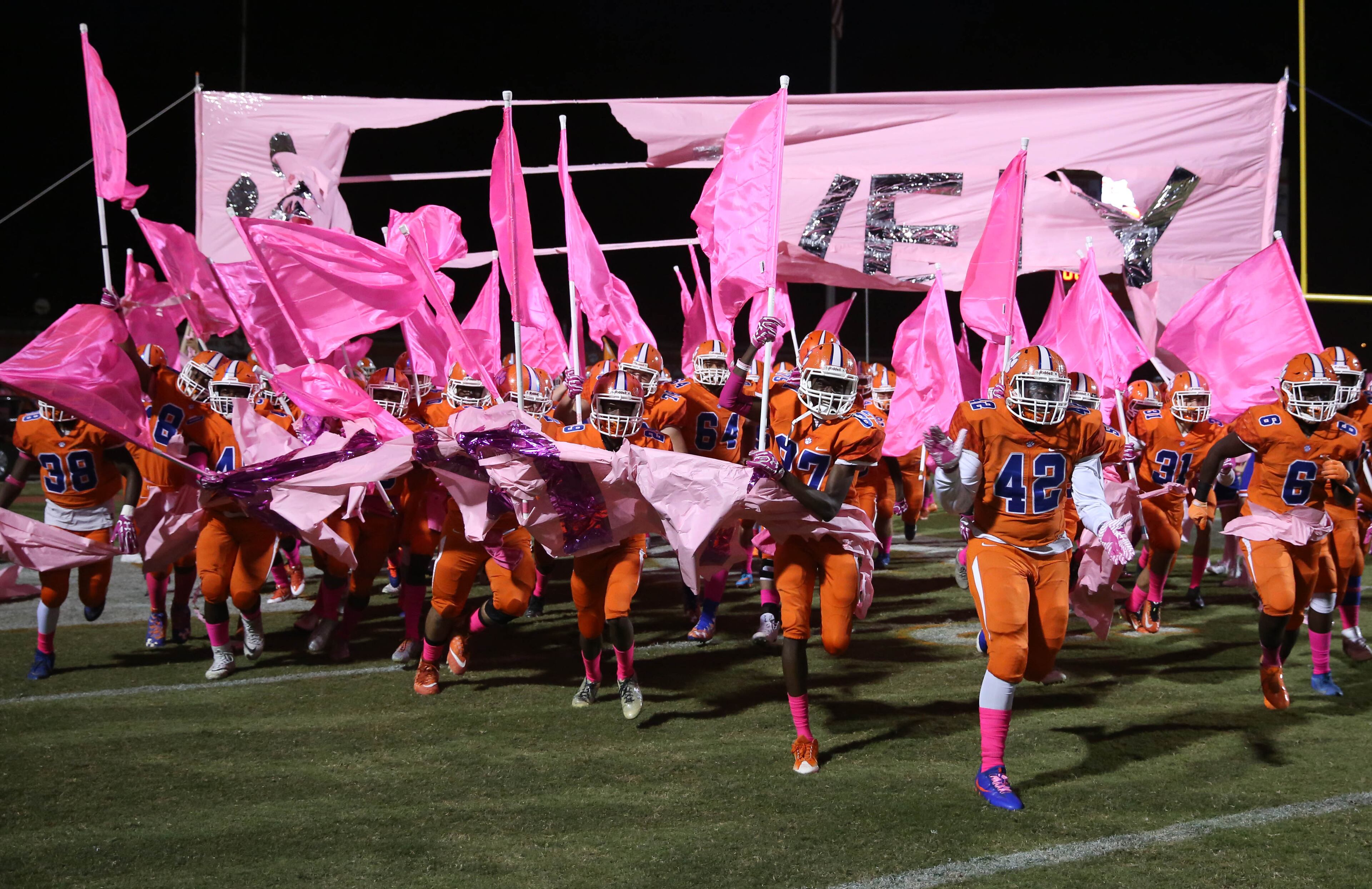 October 20, 2017 - Lilburn, Ga: Parkview players run onto the field holding pink flags in support of Cancer Awareness Month before their game against Brookwood at Parkview High School Friday, October 20, 2017, in Lilburn, Ga.. PHOTO / JASON GETZ
