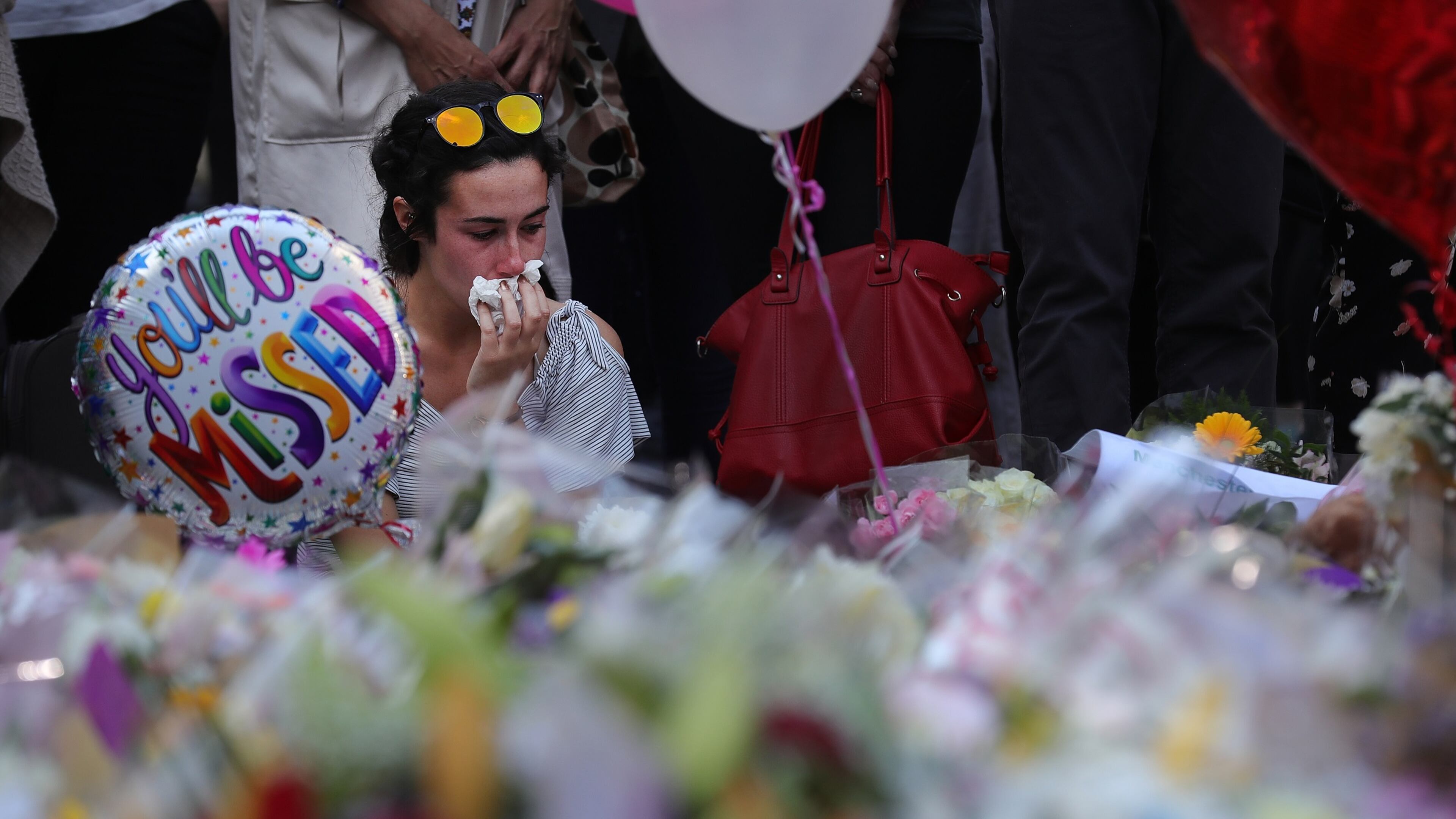 A woman pays tribute to those killed outside an Ariana Grande concert Monday night in Manchester, England. (Photo by Christopher Furlong/Getty Images)