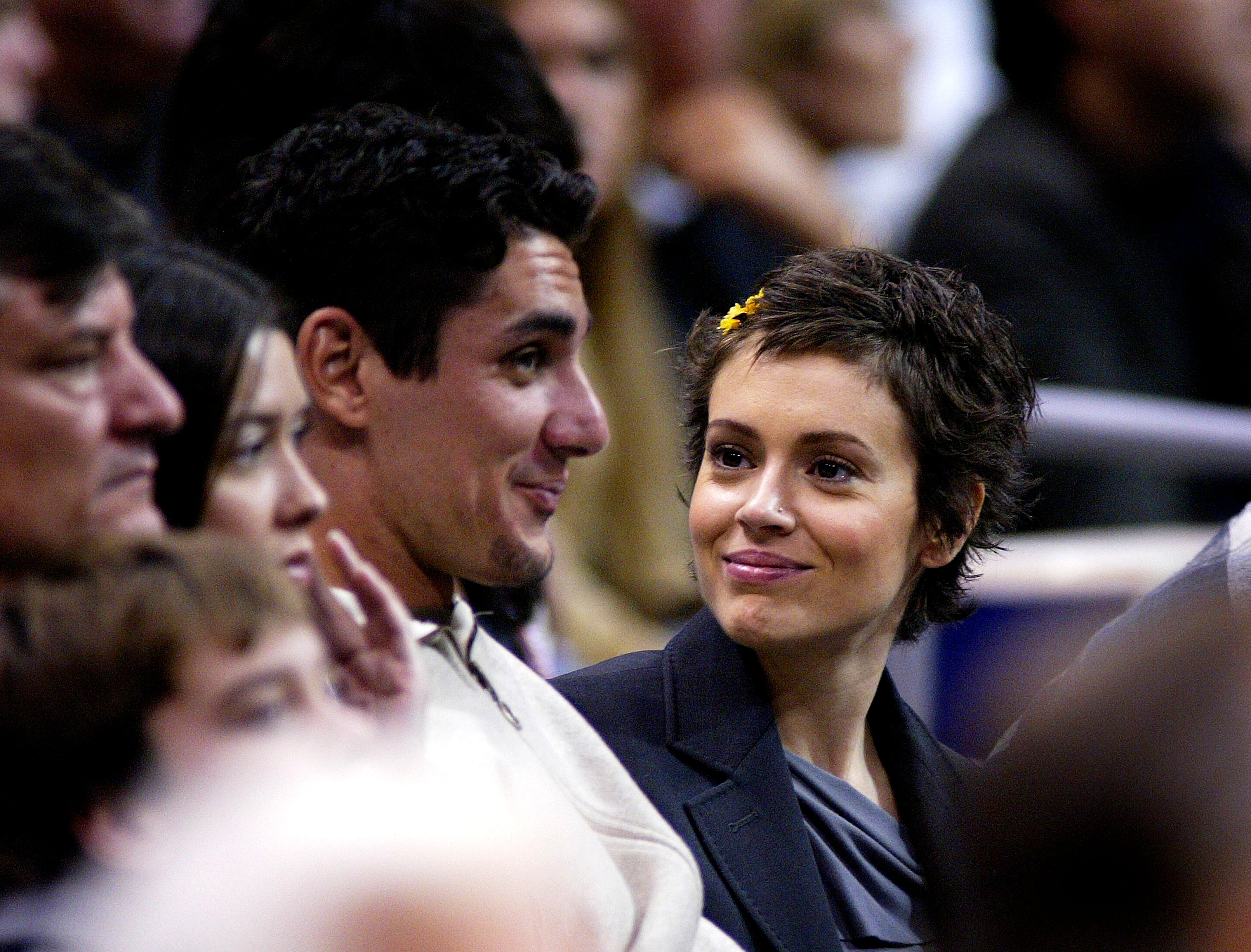 Actress Alyssa Milano and guest attend the game between the Los Angeles Lakers and the Chicago Bulls on November 21, 2003 at the Staples Center in Los Angeles, California. (Photo by Vince Bucci/Getty Images)