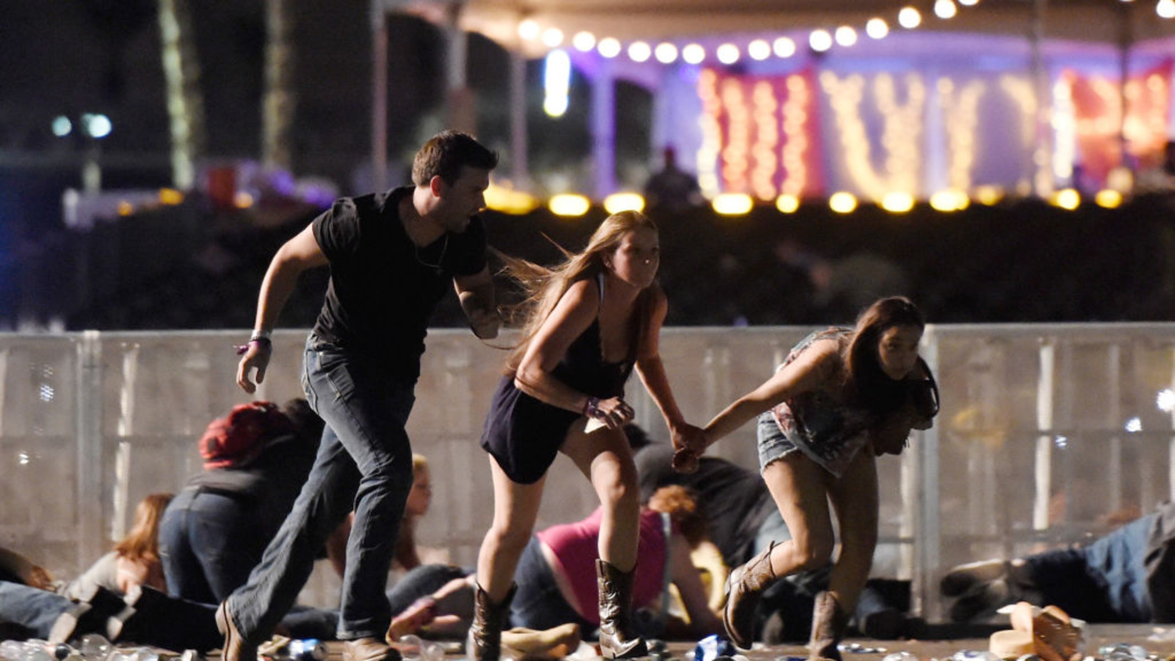 People run from the Route 91 Harvest country music festival after shots were fired on Oct. 1 in Las Vegas.