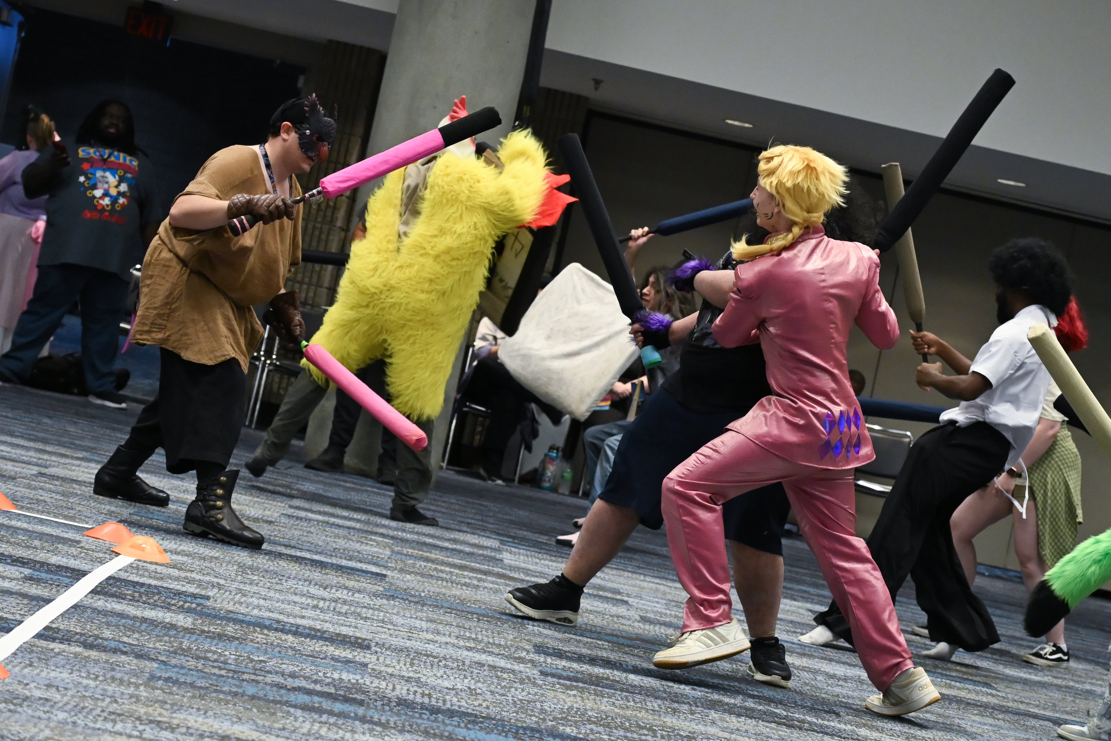 Attendees duel with toy swords during MomoCon at the Georgia World Congress Center in Atlanta on Friday, May 22, 2026. (Tyler Sun for the AJC)
