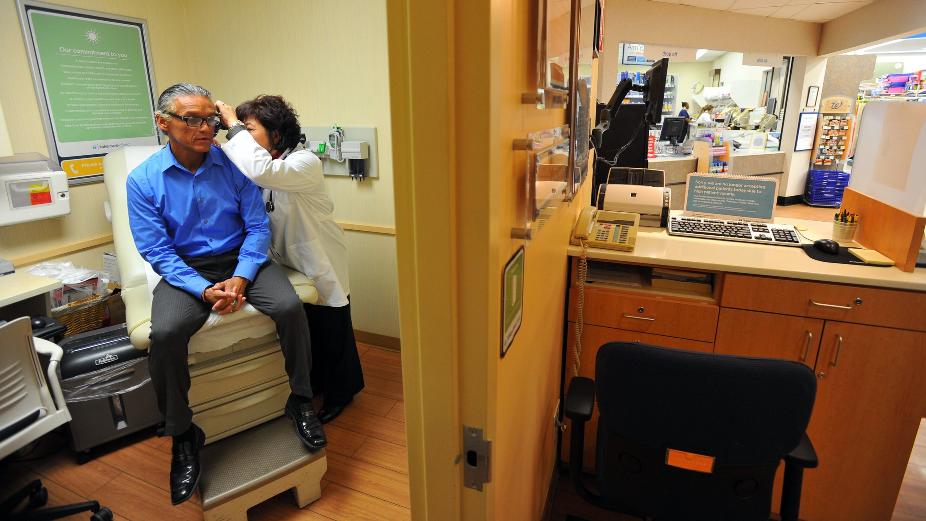 In this 2011 photo, a nurse practitioner examines a patient at a Walgreens on Roswell Road. Piedmont Healthcare will run Walgreens clinics starting later this year. Emory Healthcare has a similar deal with rival CVS. Brant Sanderlin bsanderlin@ajc.com