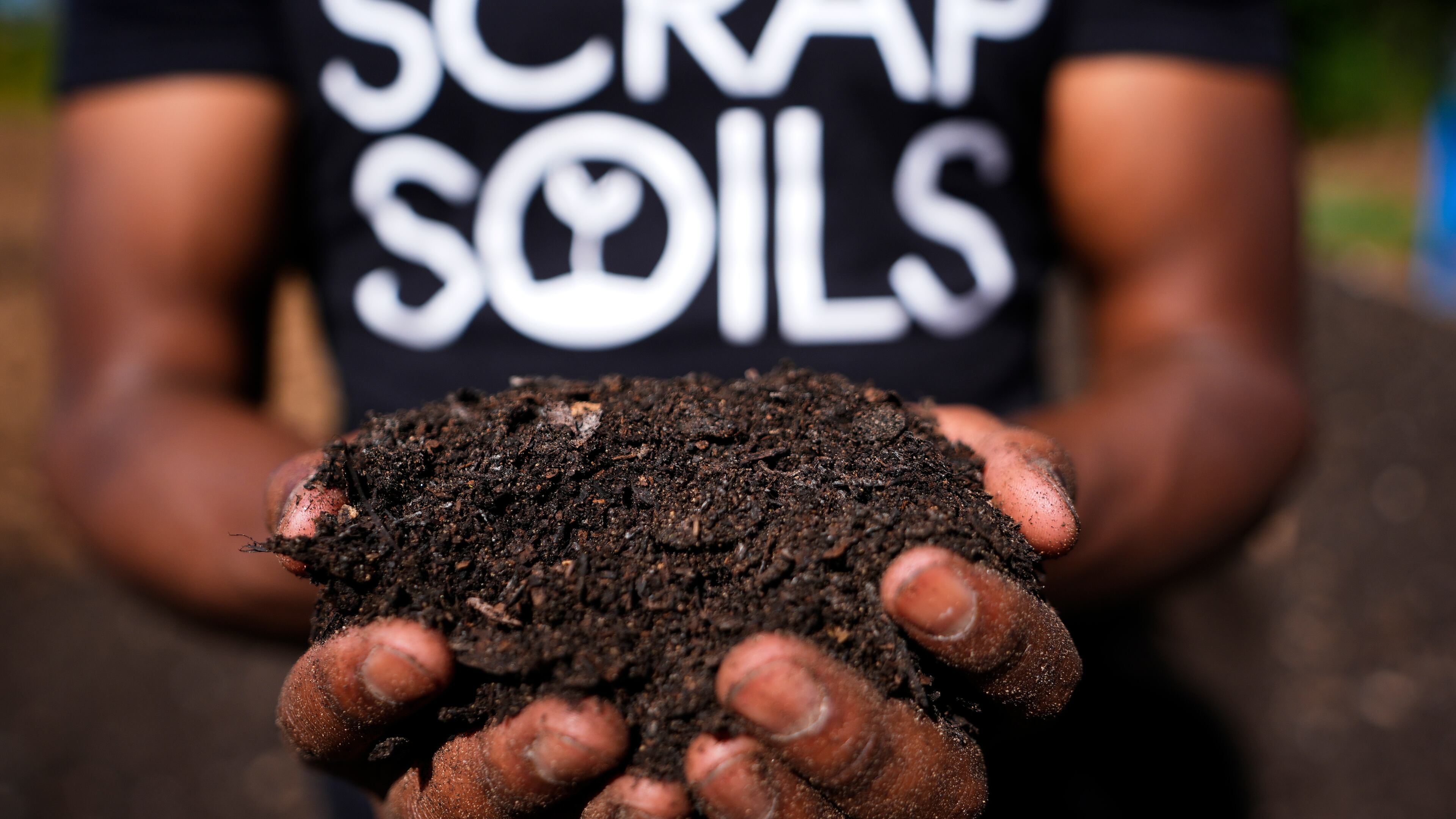Ricky Blanding, founder of Scrap Soils, holds composted soil at Sanctuary Farms, Monday, Sept. 14, 2026, in Detroit. (AP Photo/Paul Sancya)