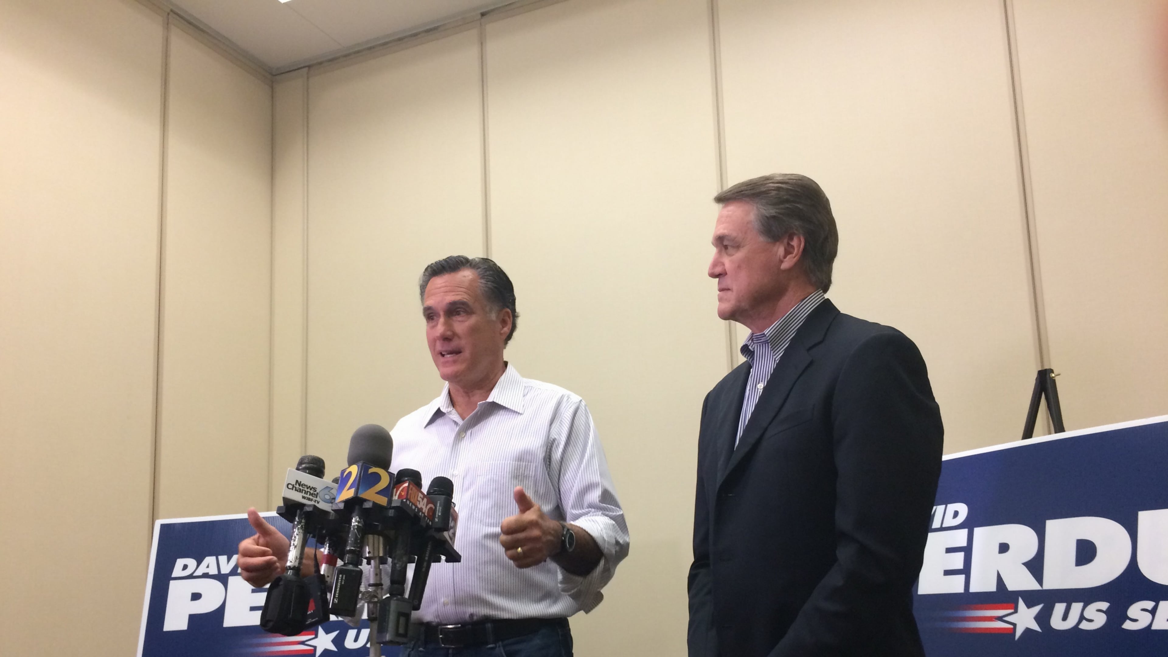 Mitt Romney and David Perdue speak to reporters in Augusta (AJC/Daniel Malloy)