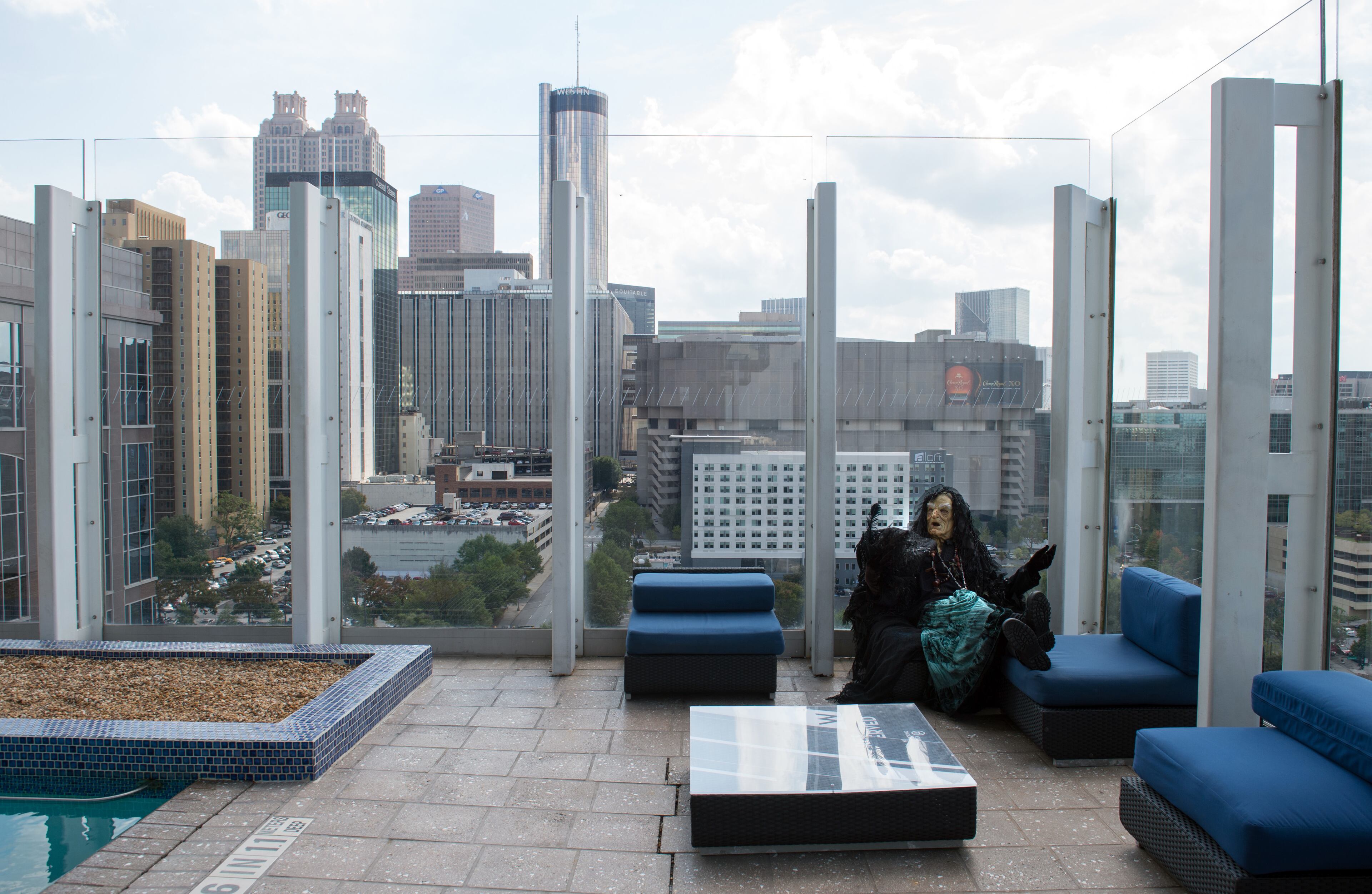 Hagatha the Witch from Netherworld Haunted House in Norcross lounges by the swimming pool at W Atlanta Downtown hotel on Thursday, October 7, 2014. HYOSUB SHIN / HSHIN@AJC.COM