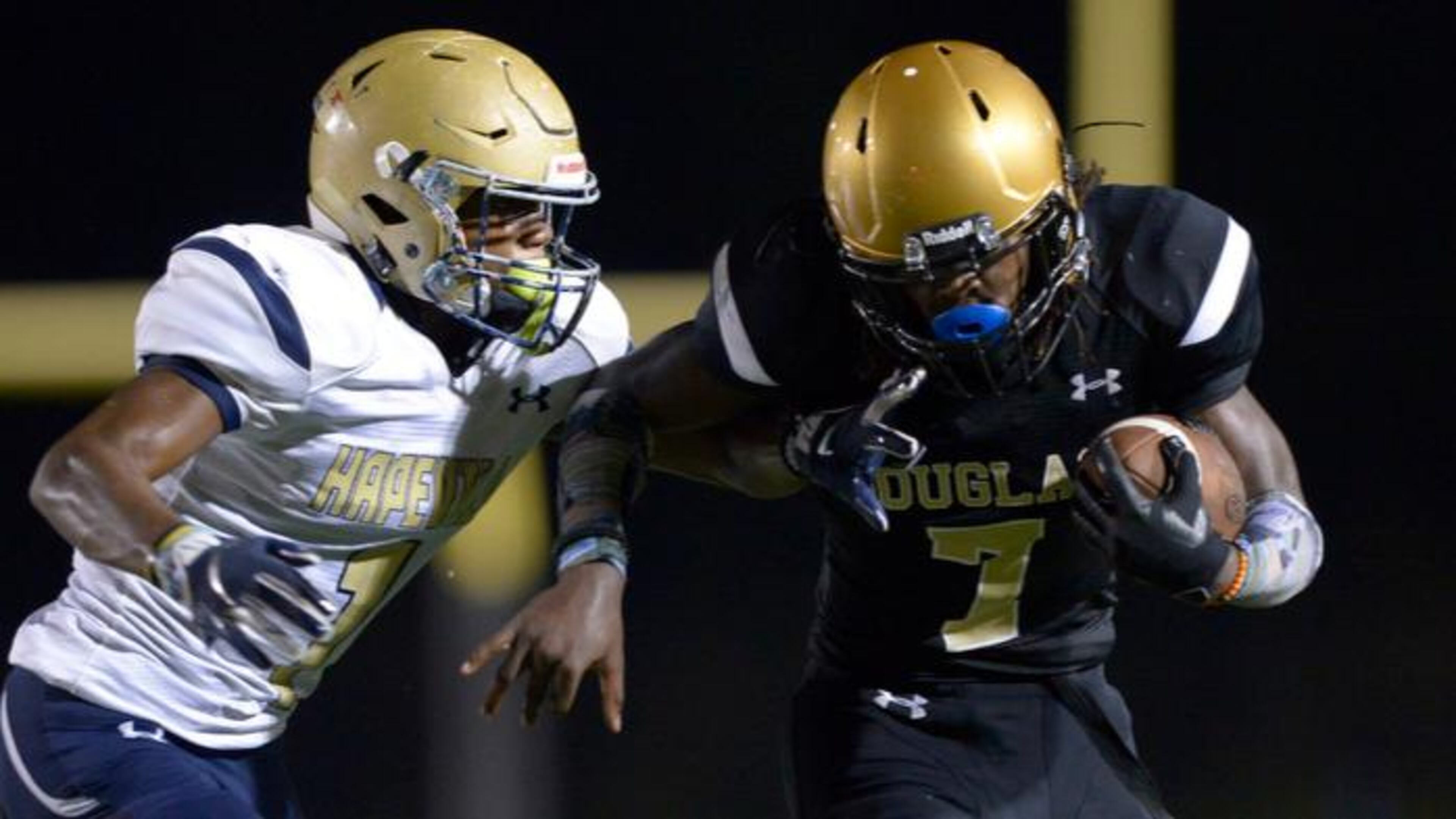 Douglass senior QB Juan Powell (7) is pursued by Hapeville Charter senior CB Malik Fleming (1) late in the first half of their game Friday, September 28, 2018 at Lakewood Stadium. PHOTO/Daniel Varnado