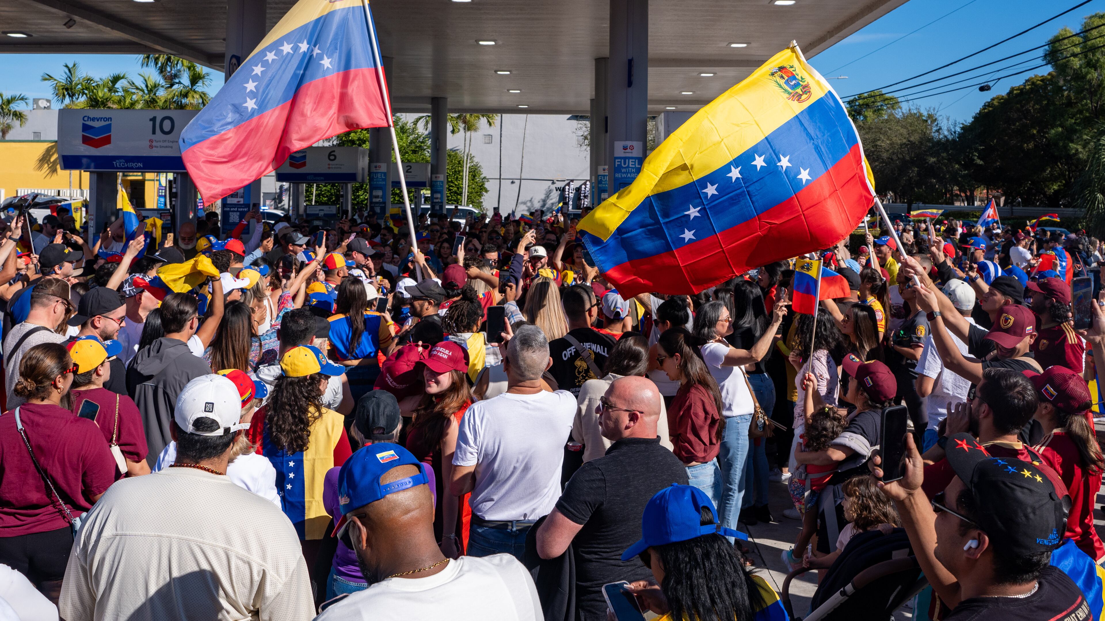 People celebrate after President Donald Trump announced Venezuelan President Nicolás Maduro had been captured and flown out of the country, in Doral, Fla., Saturday, Jan. 3, 2026. (AP Photo/Jen Golbeck)