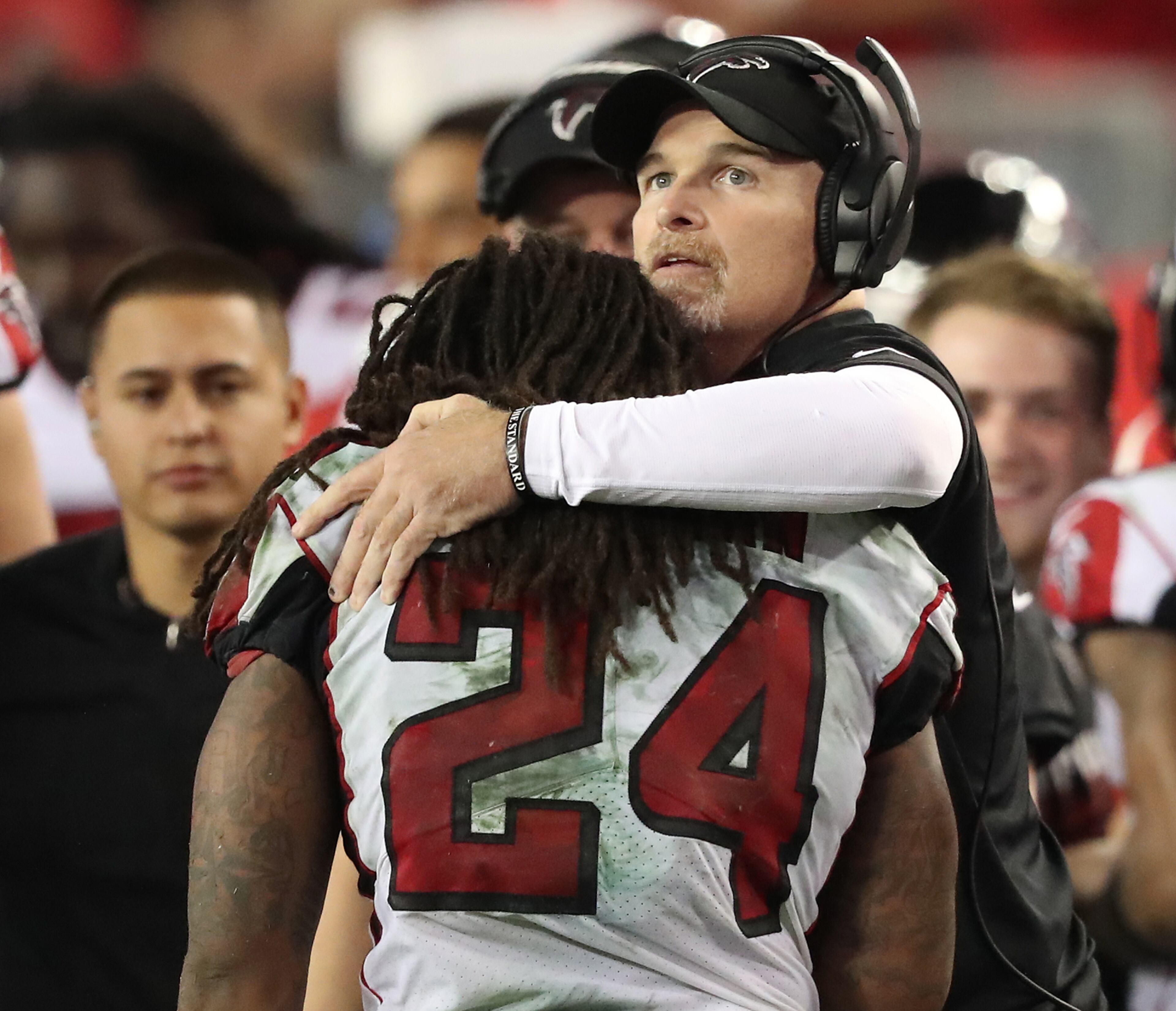 December 18, 2017 Tampa: Falcons head coach Dan Quinn gives running back Devonta Freeman a hug after his touchdown run against the Buccaneers for a 24-14 lead during the fourth quarter in a NFL football game on Monday, December 18, 2017, in Tampa. The Falcons held on to beat the Bucs 24-21. Curtis Compton/ccompton@ajc.com