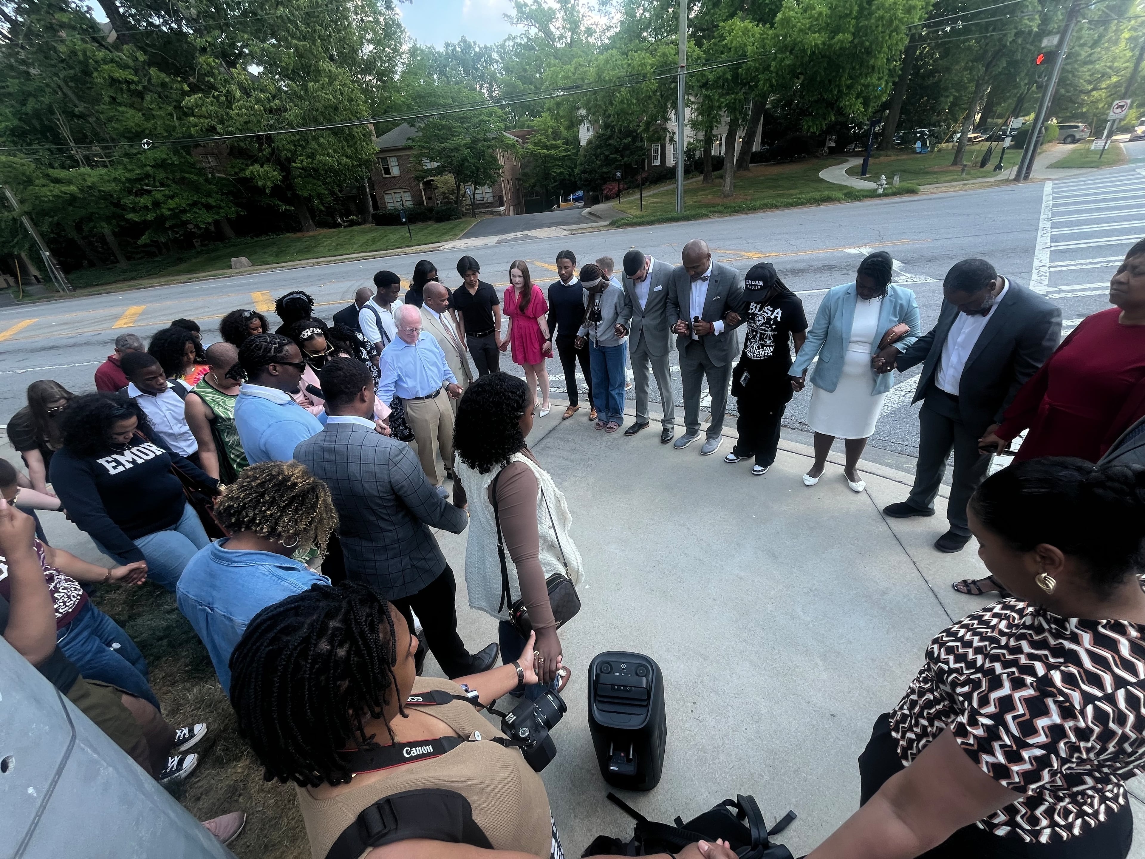 Local attorneys outside of the Emory University School of Law end their demonstration with a prayer on Thursday, April 23, 2026. The group criticized the school for how it handled a series of disturbing social media posts and threatening emails from a student. (Jason Armesto/AJC)