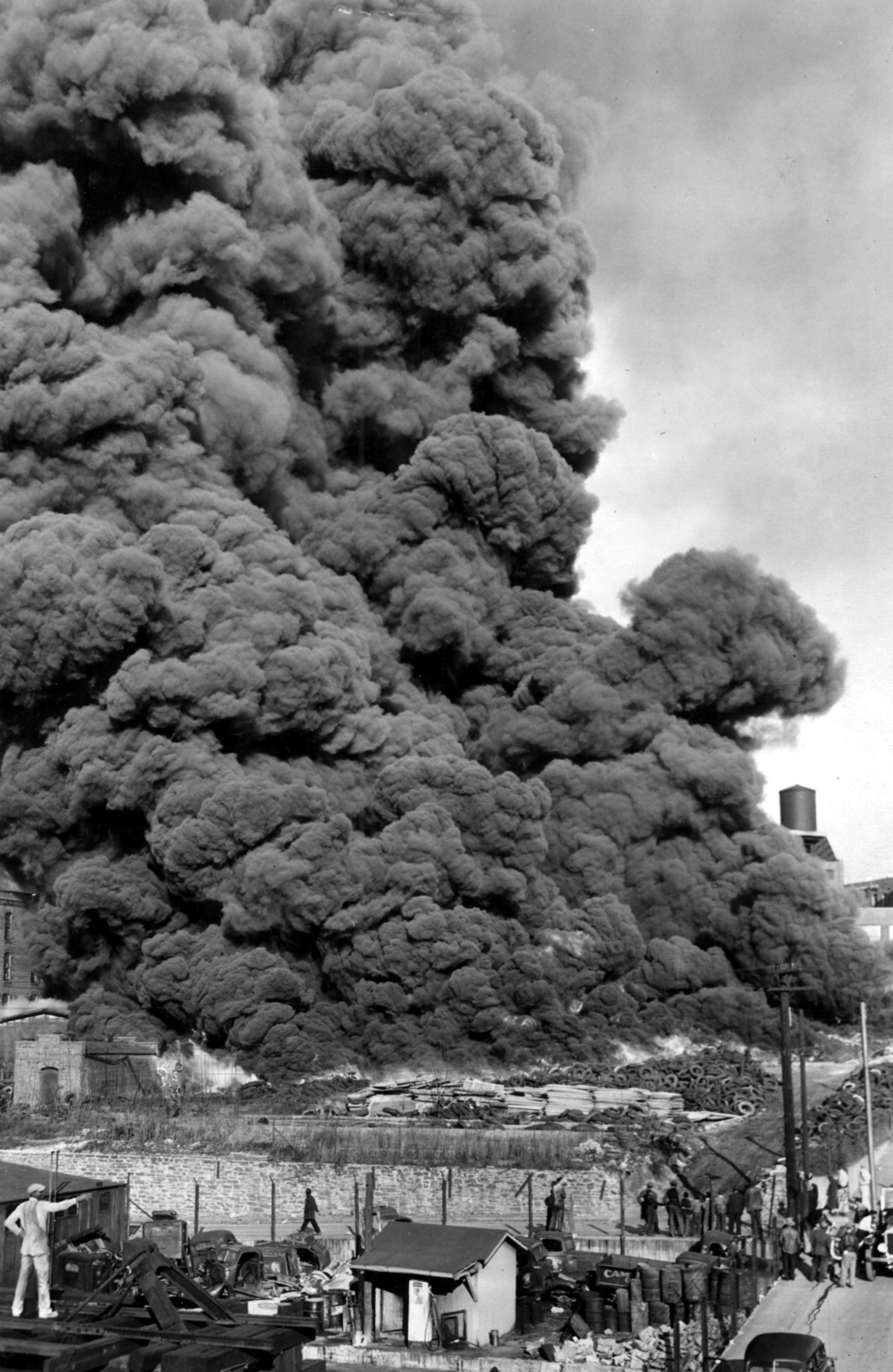 Burning tires on the stockpile of the Dixie Rubber Company send foul smelling smoke high into the air on a Monday afternoon. Almost a million scrap tires were consumed in the February 1946 fire.