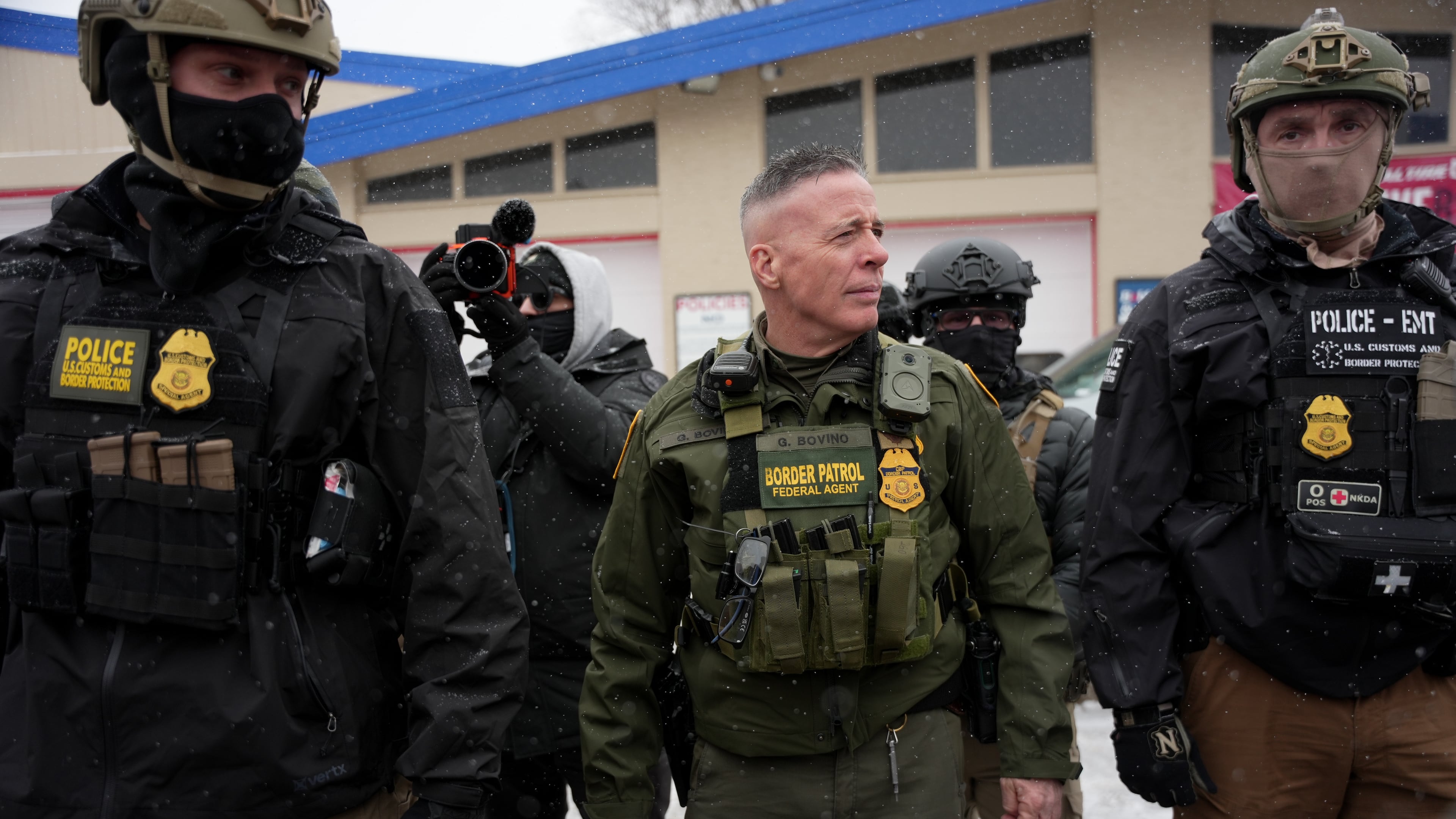FILE - U.S. Border Patrol Cmdr. Gregory Bovino walks with federal agents outside a convenience store on Jan. 21, 2026, in Minneapolis. (AP Photo/Angelina Katsanis, File)