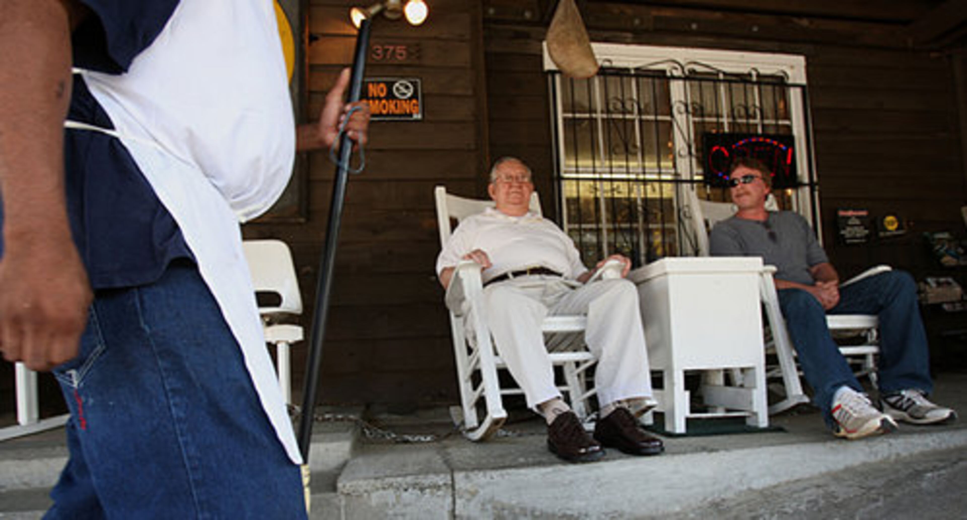 Bobby Crowe, 79, with longtime customer Danny Wood, 53, chat by the entrance of his restaurant.