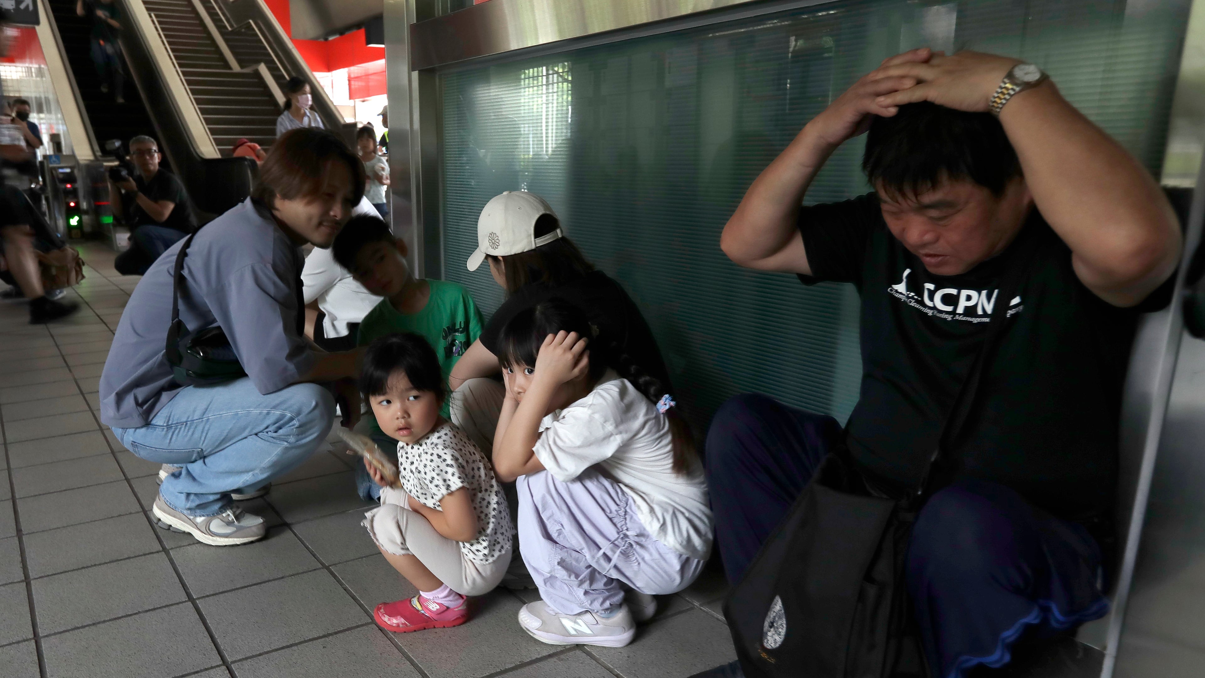 People take cover inside at a MRT station during the Urban Resilience (Air-Defense) Exercise, part of the annual Han Kuang military exercises in Taipei, Taiwan, Thursday, Aug. 13, 2026. (AP Photo/Chiang Ying-ying)