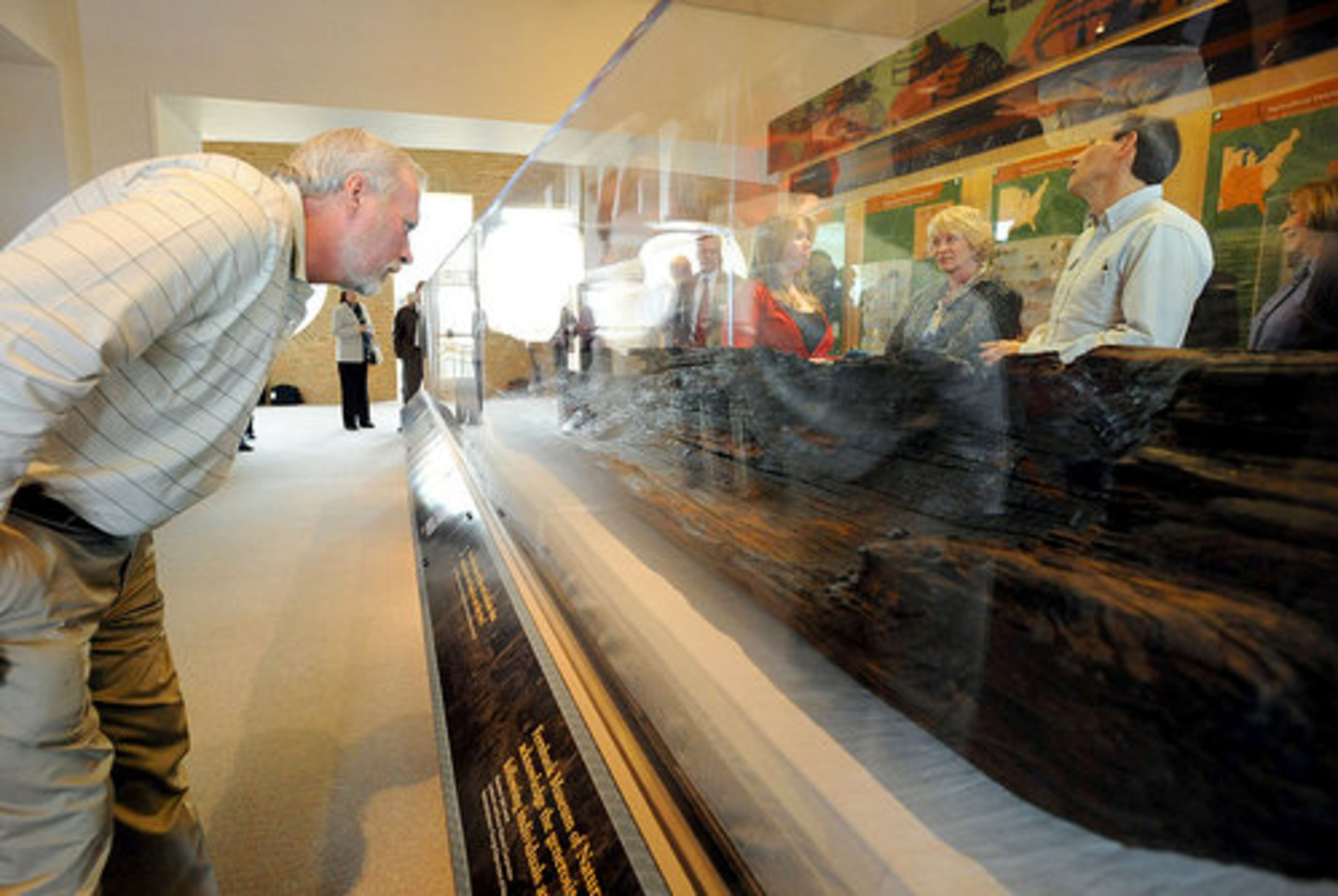 Josh Landon (left), who originally found the canoe, takes another look.
