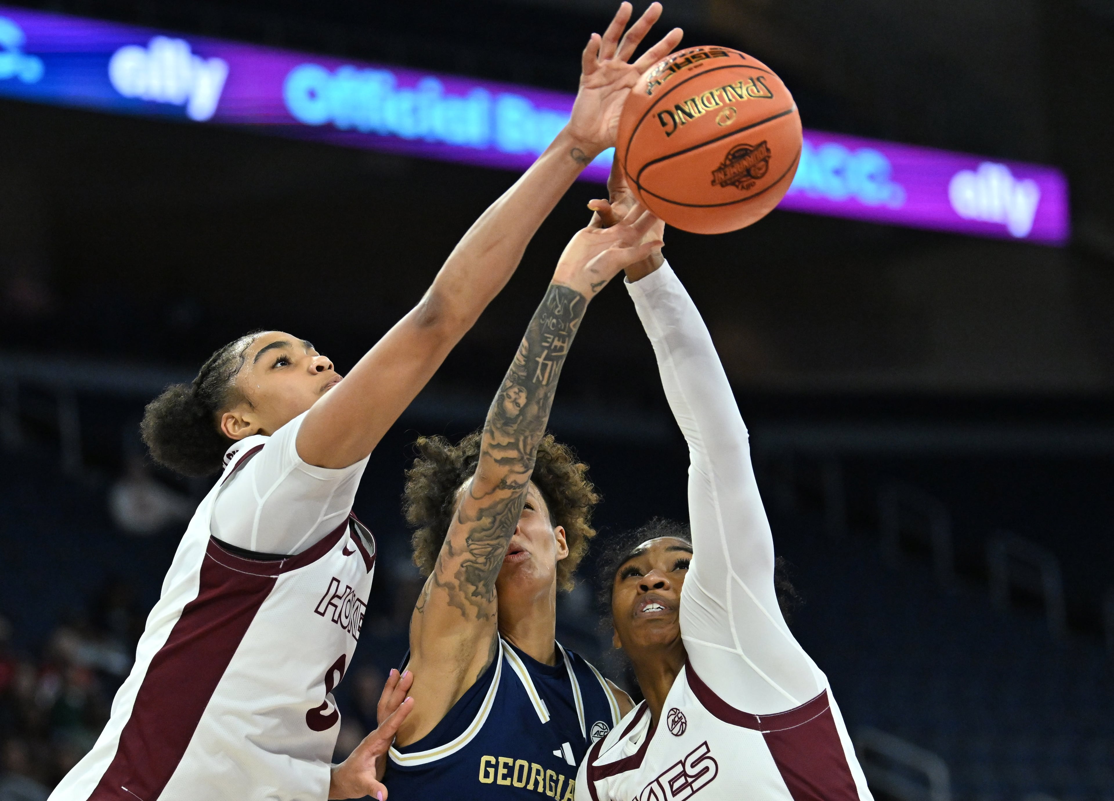 Georgia Tech guard Erica Moon (center) fights for a loose ball against Virginia Tech forward Kilah Freelon (left) and Virginia Tech guard Leila Wells during the ACC women’s basketball tournament at Gas South Arena on Thursday, March 5, 2026, in Duluth. (Hyosub Shin/AJC)