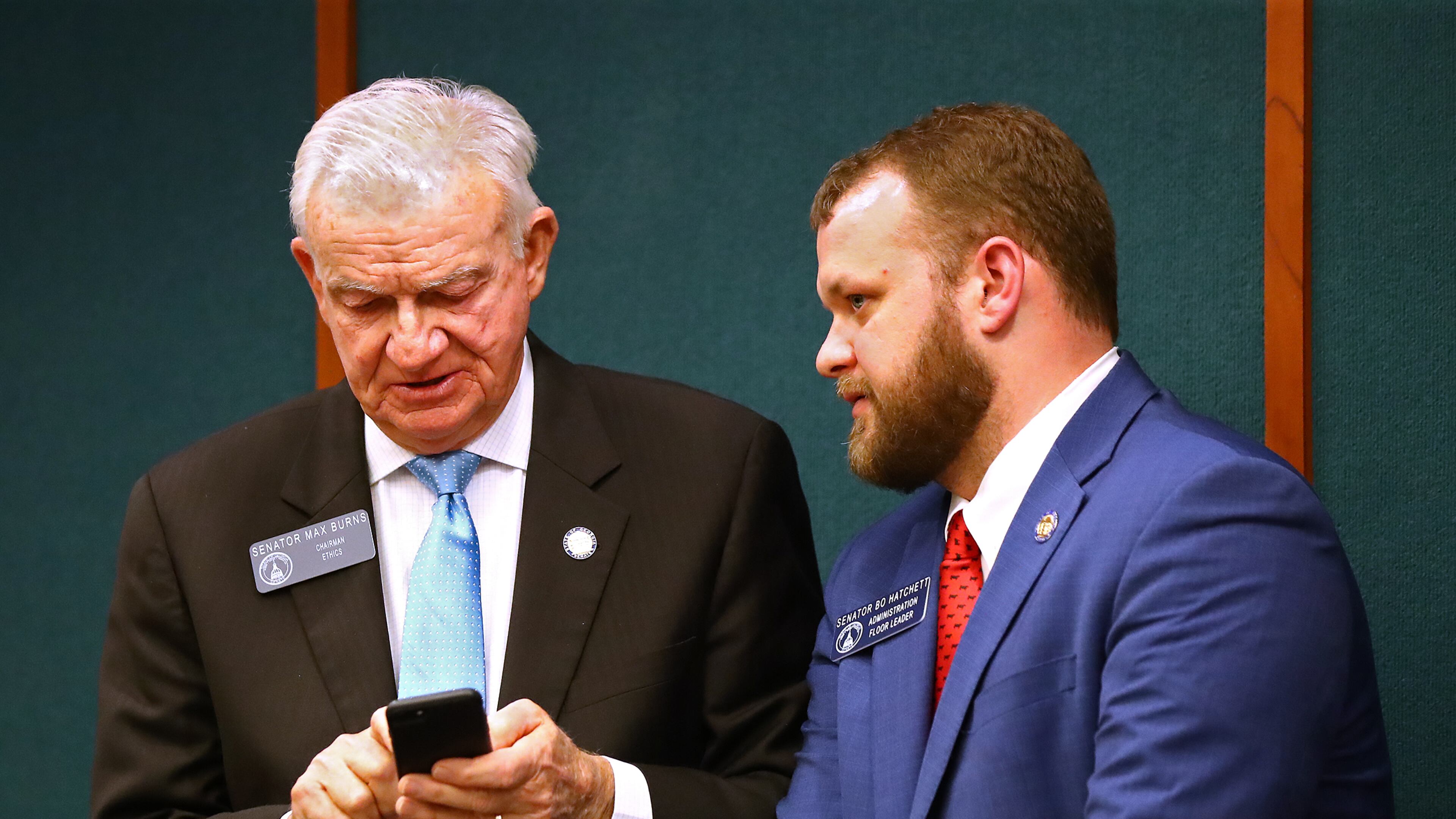 State Sen. Max Burns (left), chairman of the Senate Ethics Committee, has proposed legislation that would make the printed words on ballots the official vote instead of bar codes that are used now but are unreadable by the human eye. CURTIS COMPTON