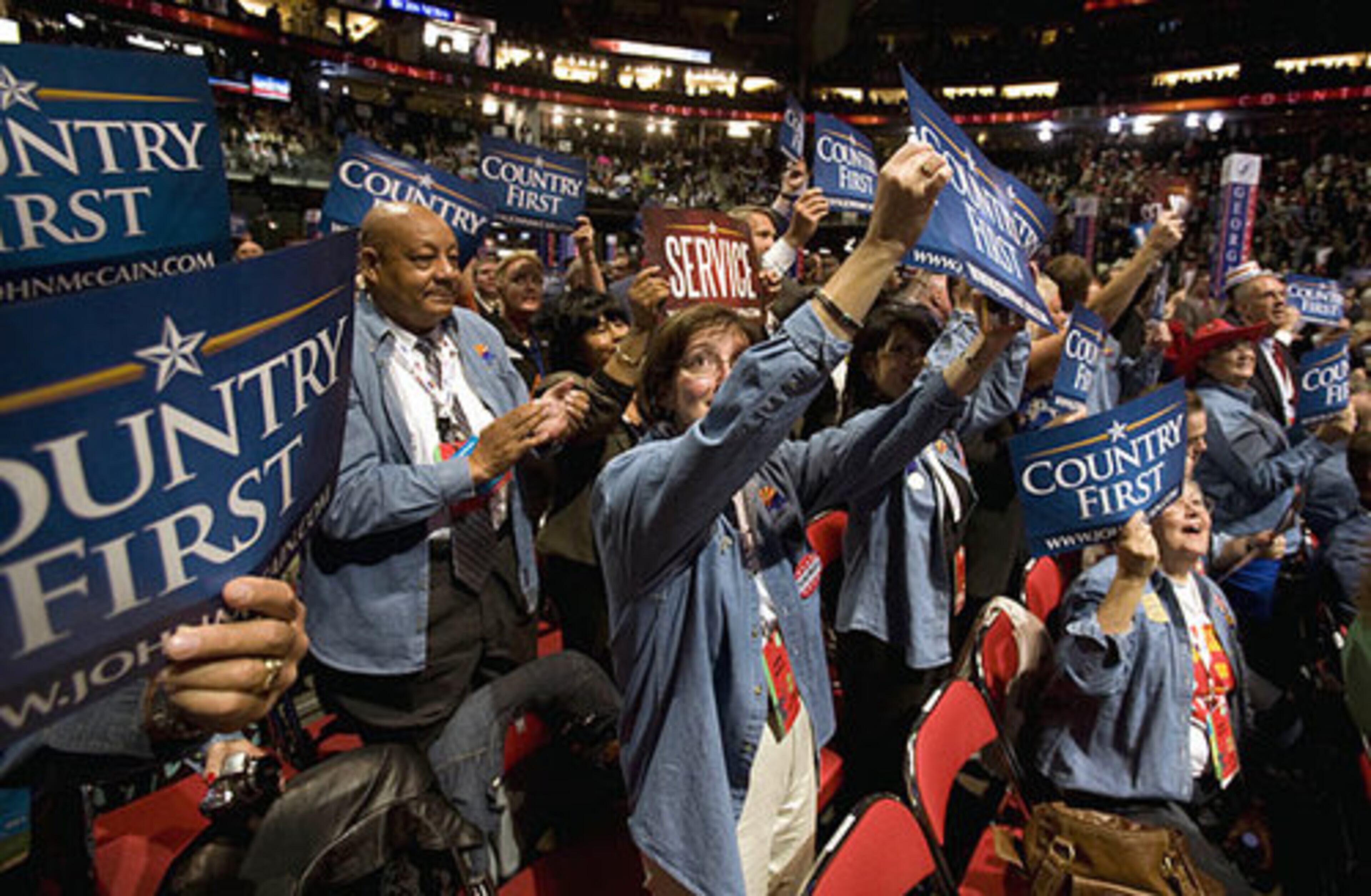 Members of the Arizona and Georgia delegations cheer Tuesday night after a video presentation about John McCain's wife, Cindy.