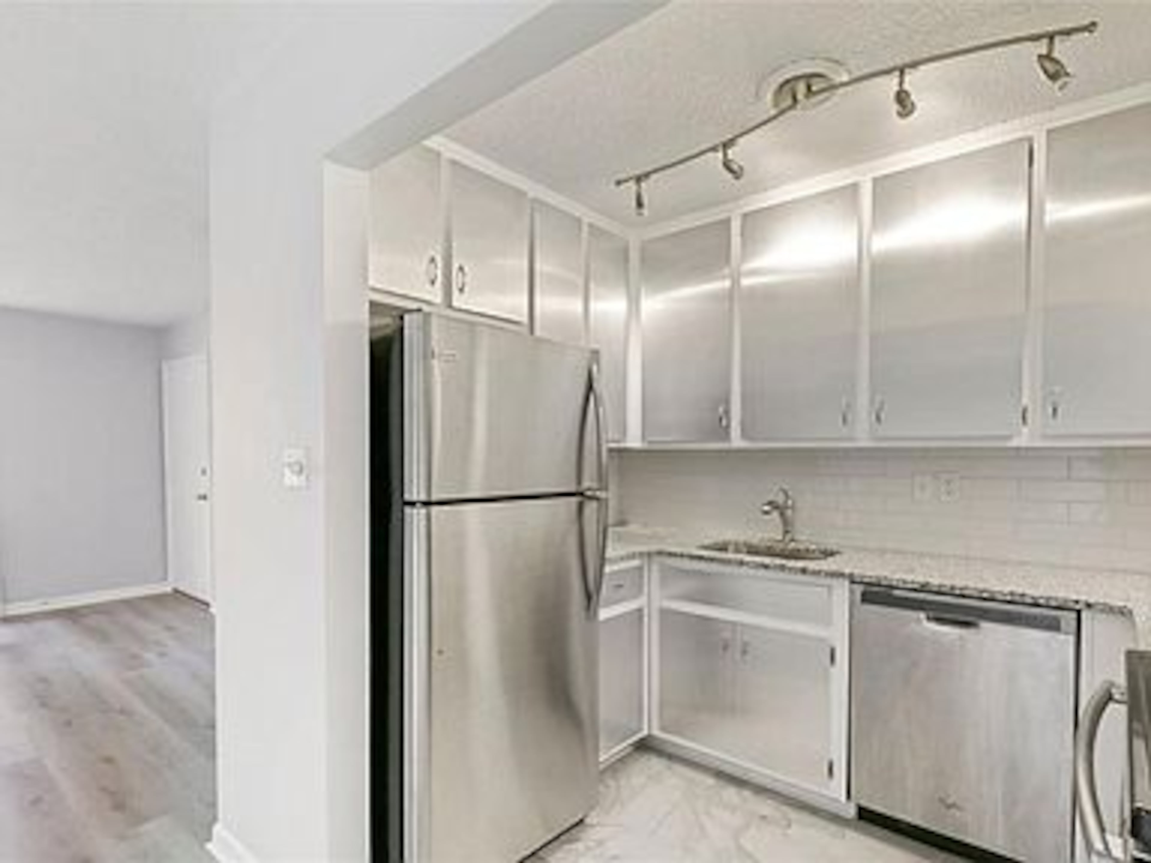 Stainless steel appliances and natural granite countertops are features of the kitchen.