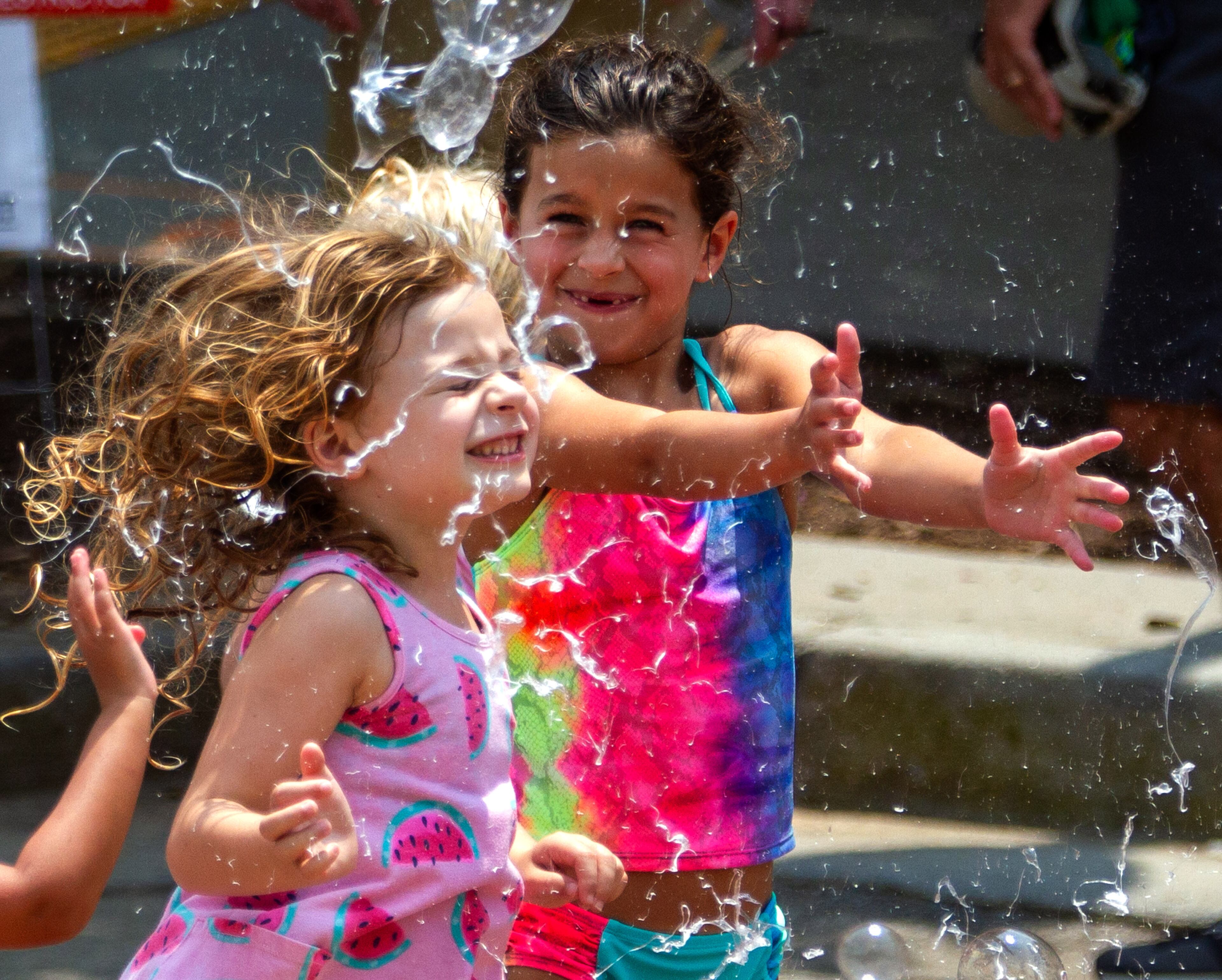 Kids pop large bubbles created by Deborah Mosher during the Brookhaven Cherry Blossom Festival on Saturday, July 31, 2021. STEVE SCHAEFER FOR THE ATLANTA JOURNAL-CONSTITUTION