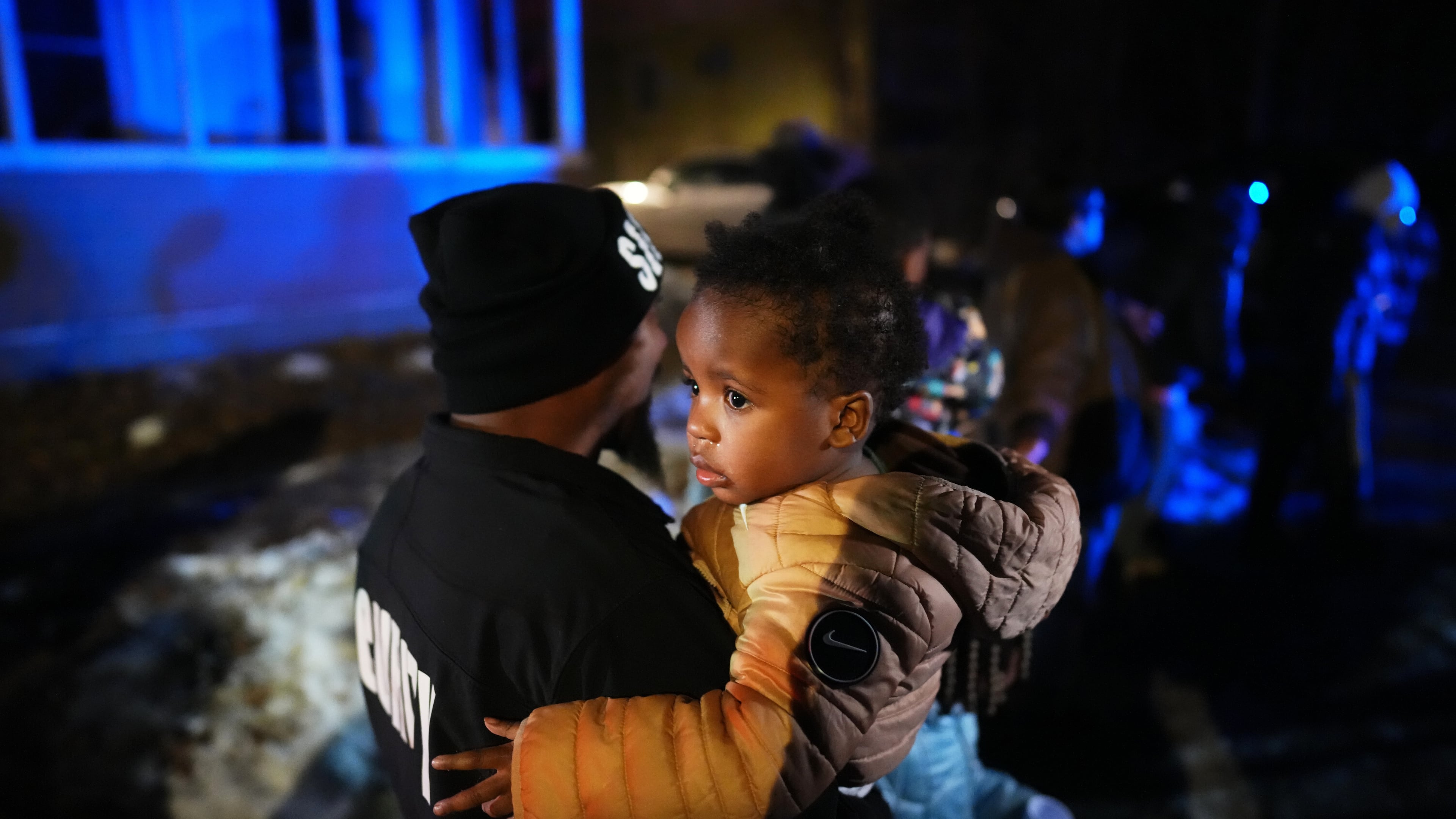 A child and family are escorted away after federal law enforcement deployed tear gas in a neighborhood during protests on Wednesday, Jan. 14, 2026, in Minneapolis. (AP Photo/Adam Gray)