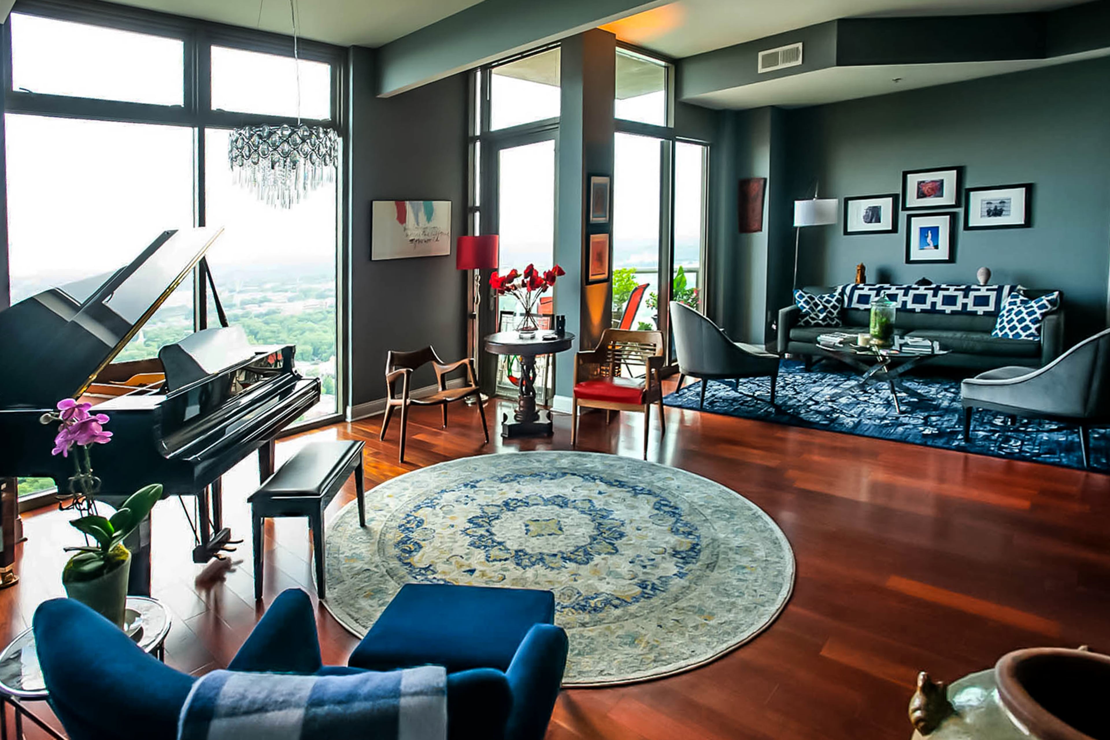 The living area is now all one open space, compared to what previously was a third bedroom before the homeowners made it their music nook. The walls are painted gray, which continues into the dining area and kitchen.