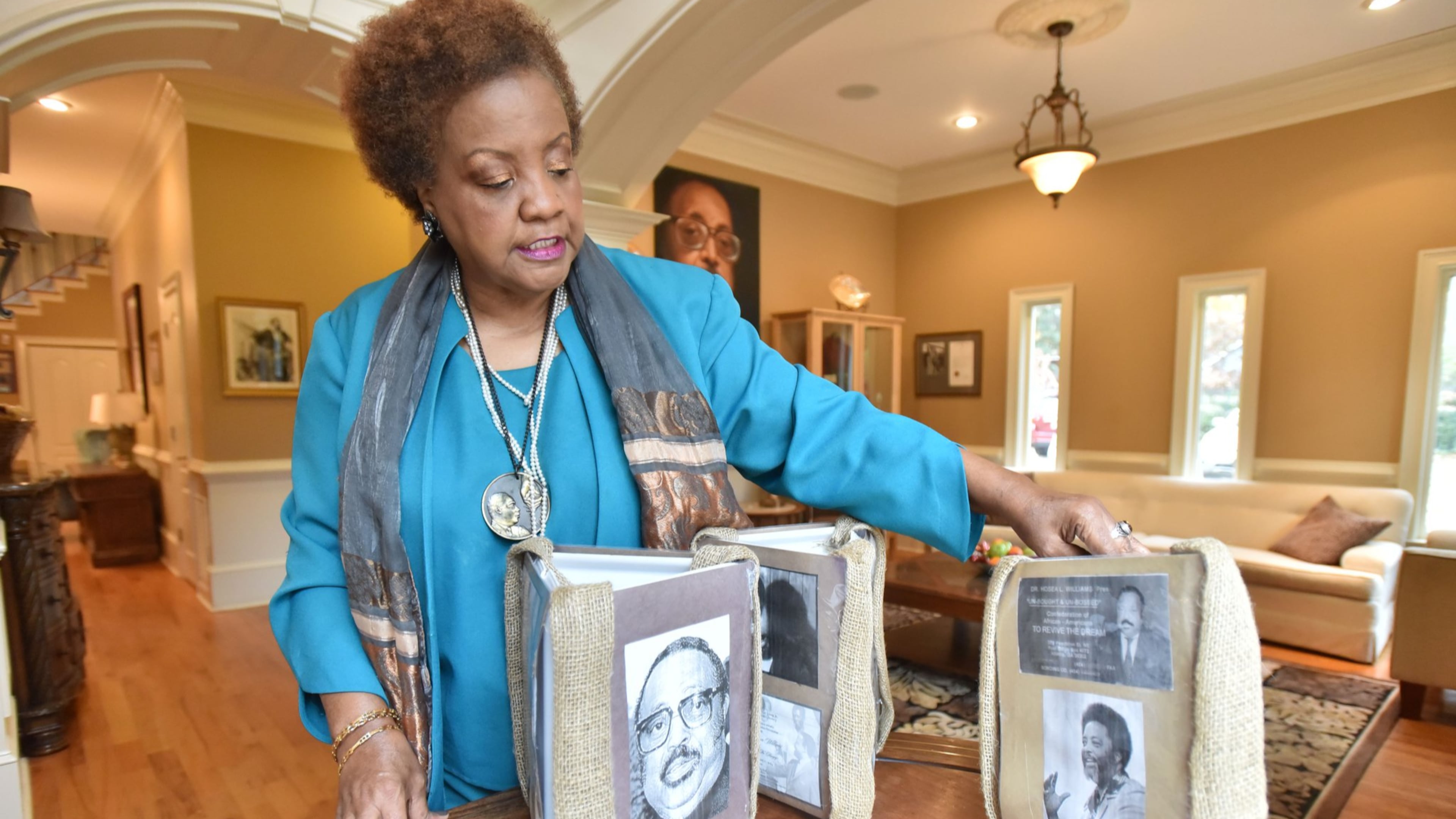 Elisabeth Williams-Omilami, daughter of Hosea Williams, shows photographs of her late father at her home on Nov. 30, 2016. HYOSUB SHIN / HSHIN@AJC.COM