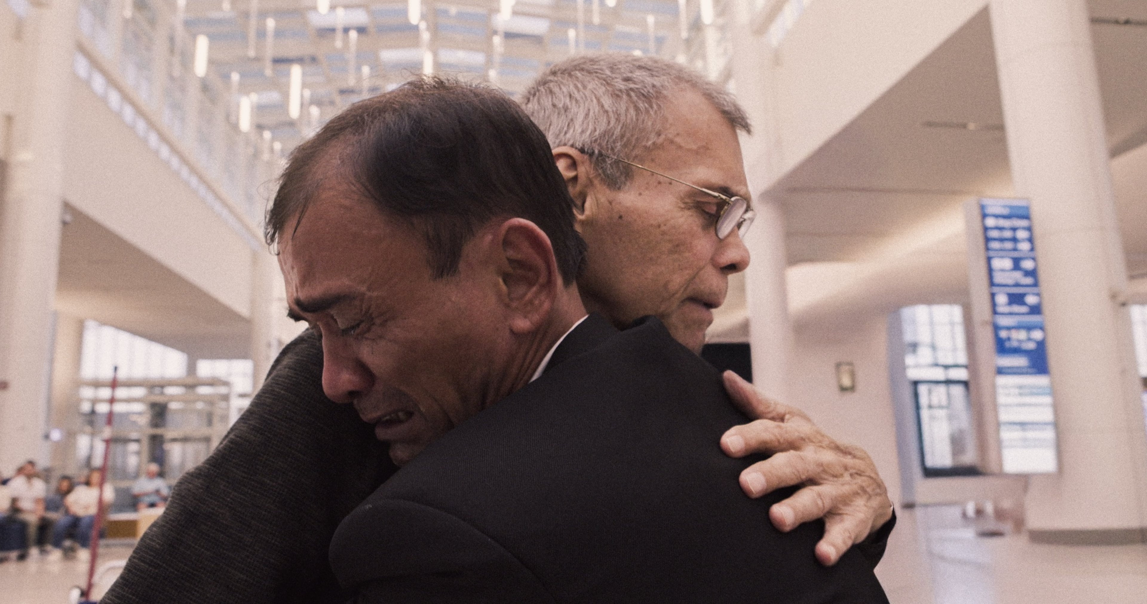 Sang Ngô Thanh (in the foreground) embraces his American father Nelson Torres for the first time as he arrives in America in the heart-wrenching documentary "Child of Dust." (Courtesy of Atlanta Film Festival)
