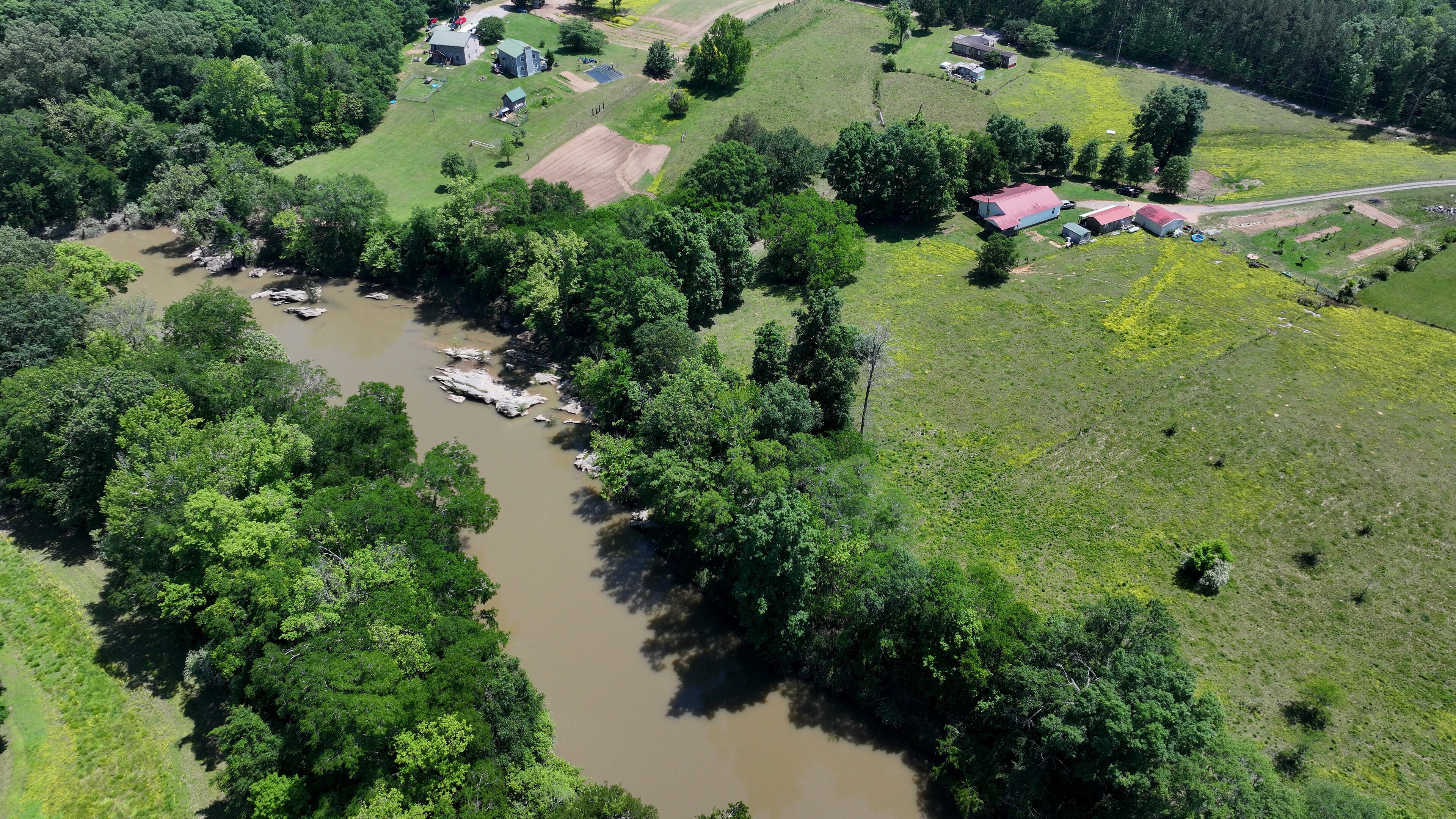 Faye Jackson has lived for decades on a patch of rural land, right, in Resaca, Ga., on the banks of the Conasauga River, seen on Thursday, May 8, 2025. (Hyosub Shin/Atlanta Journal-Constitution via AP)