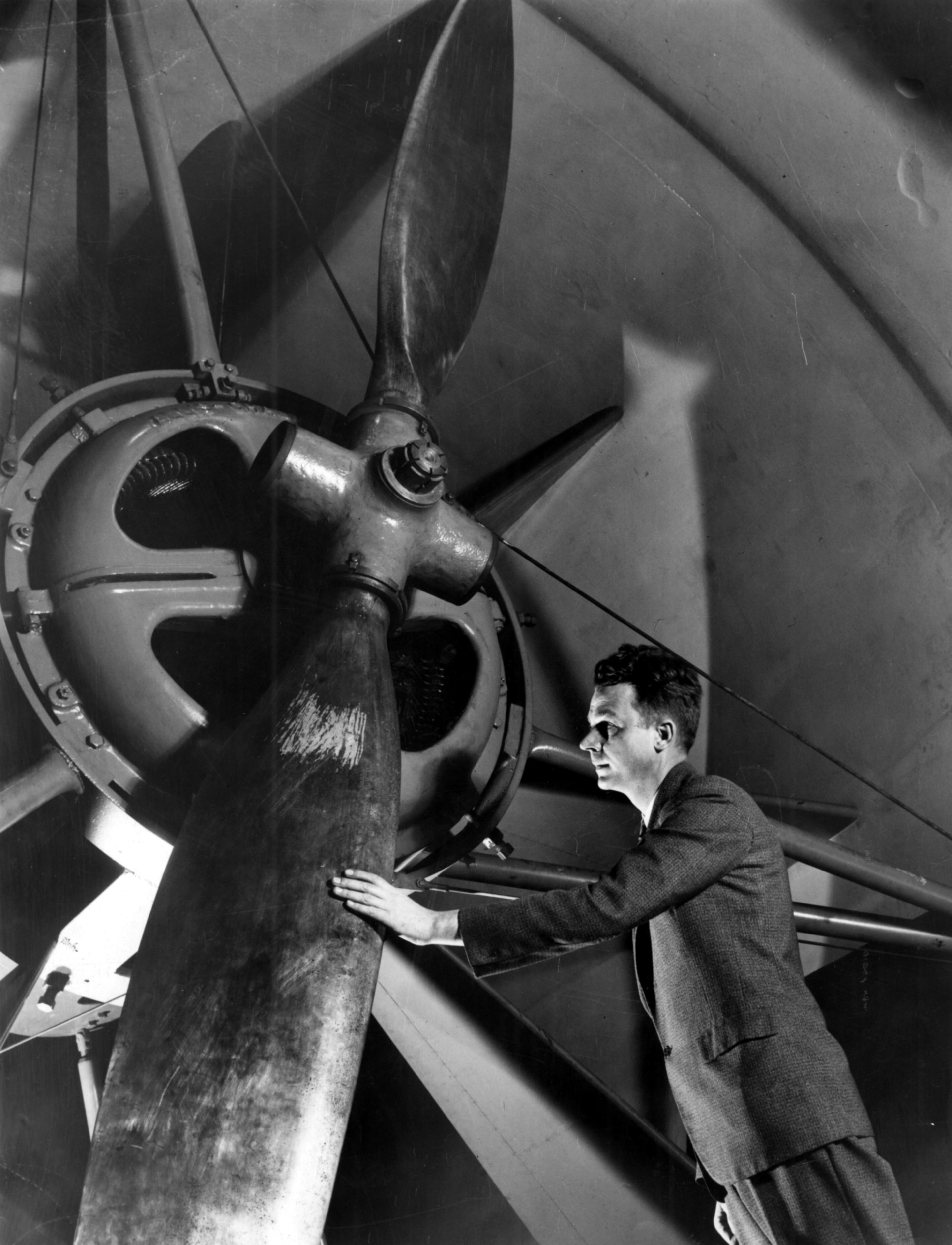 1959 -- Dr. Ralph A. Hefner of the State Engineering Experiment Station, who is assisting Tech's aeronautical engineers, is shown with a giant propeller in a wind tunnel used for experiments.