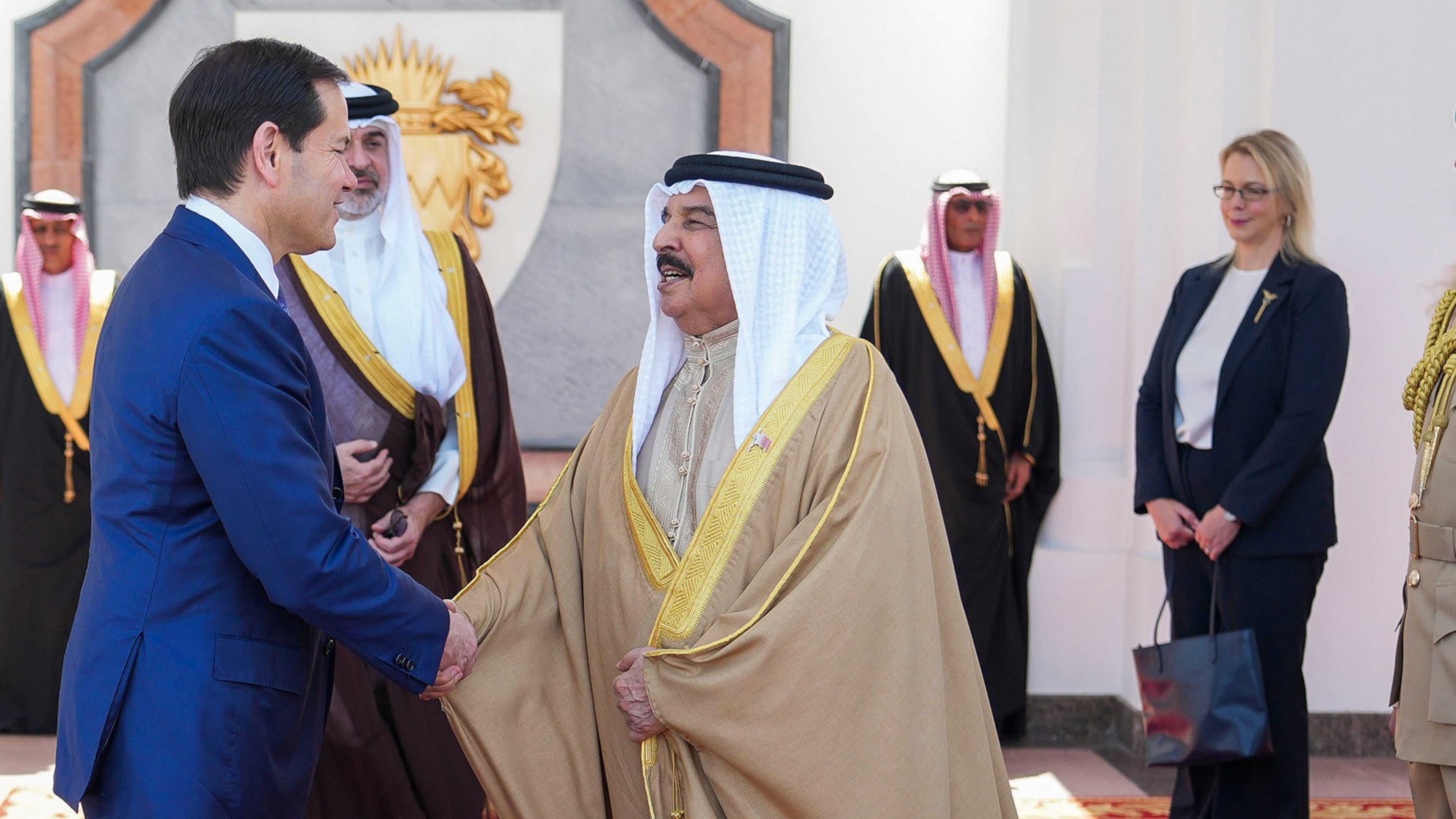 U.S. Secretary of State Marco Rubio, left, and Bahrain's King Hamad bin Isa Al Khalifa salute eachother after their meeting as U.S. Ambassador to Bahrain Stephanie Hallett looks on at right, at Al-Sakhir Palace near Zallaq, Bahrain Thursday, June 25, 2026. U.S. Ambassador to Bahrain Stephanie Hallett. (Eric Lee/Pool Photo via AP)