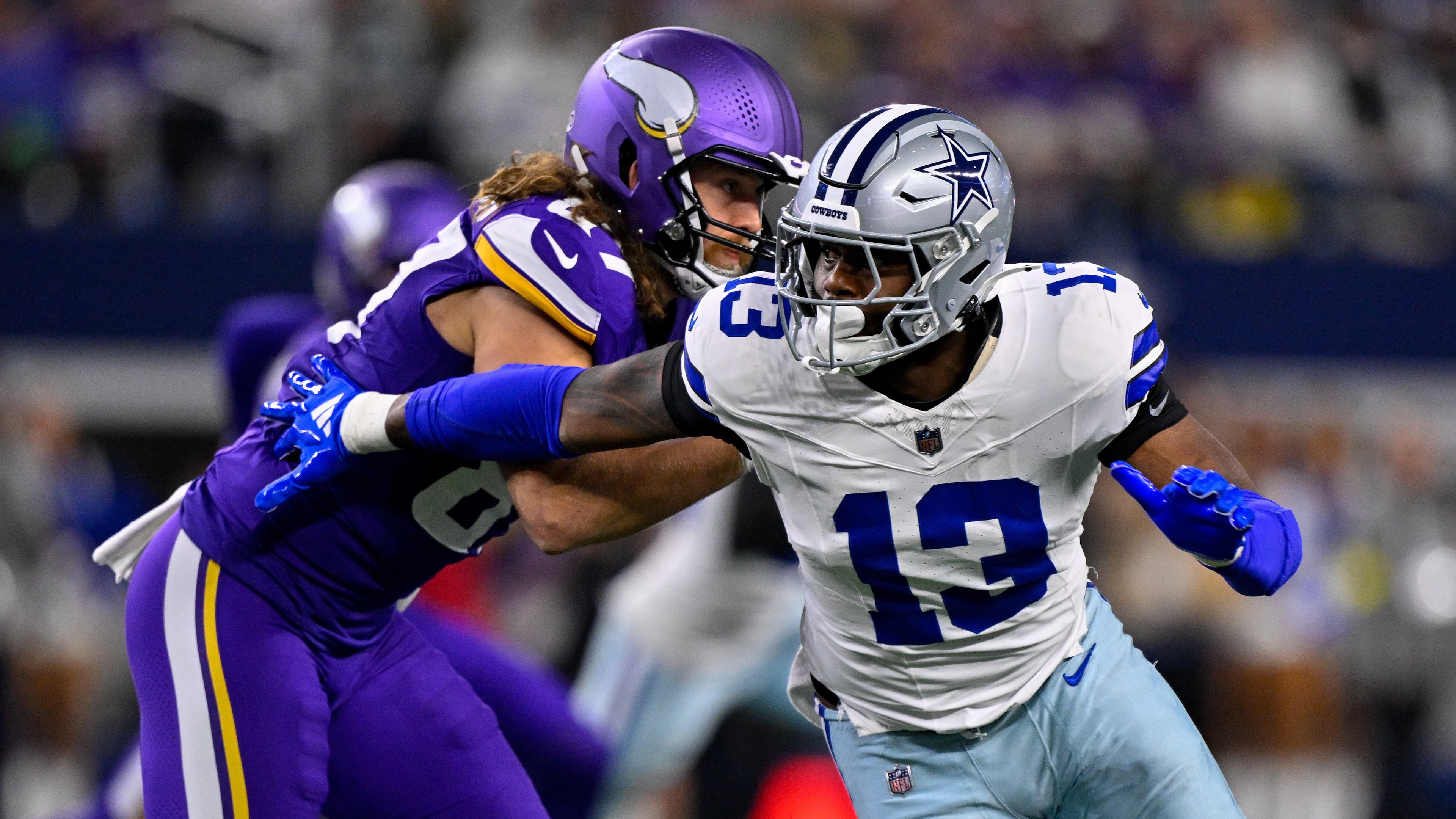 FILE - Dallas Cowboys defensive end Dante Fowler Jr. (13) rushes the line past Minnesota Vikings tight end T.J. Hockenson (87) during an NFL football game between the Dallas Cowboys and the Minnesota Vikings on Dec. 14, 2025, in Arlington, Texas. (AP Photo/Jerome Miron, File)