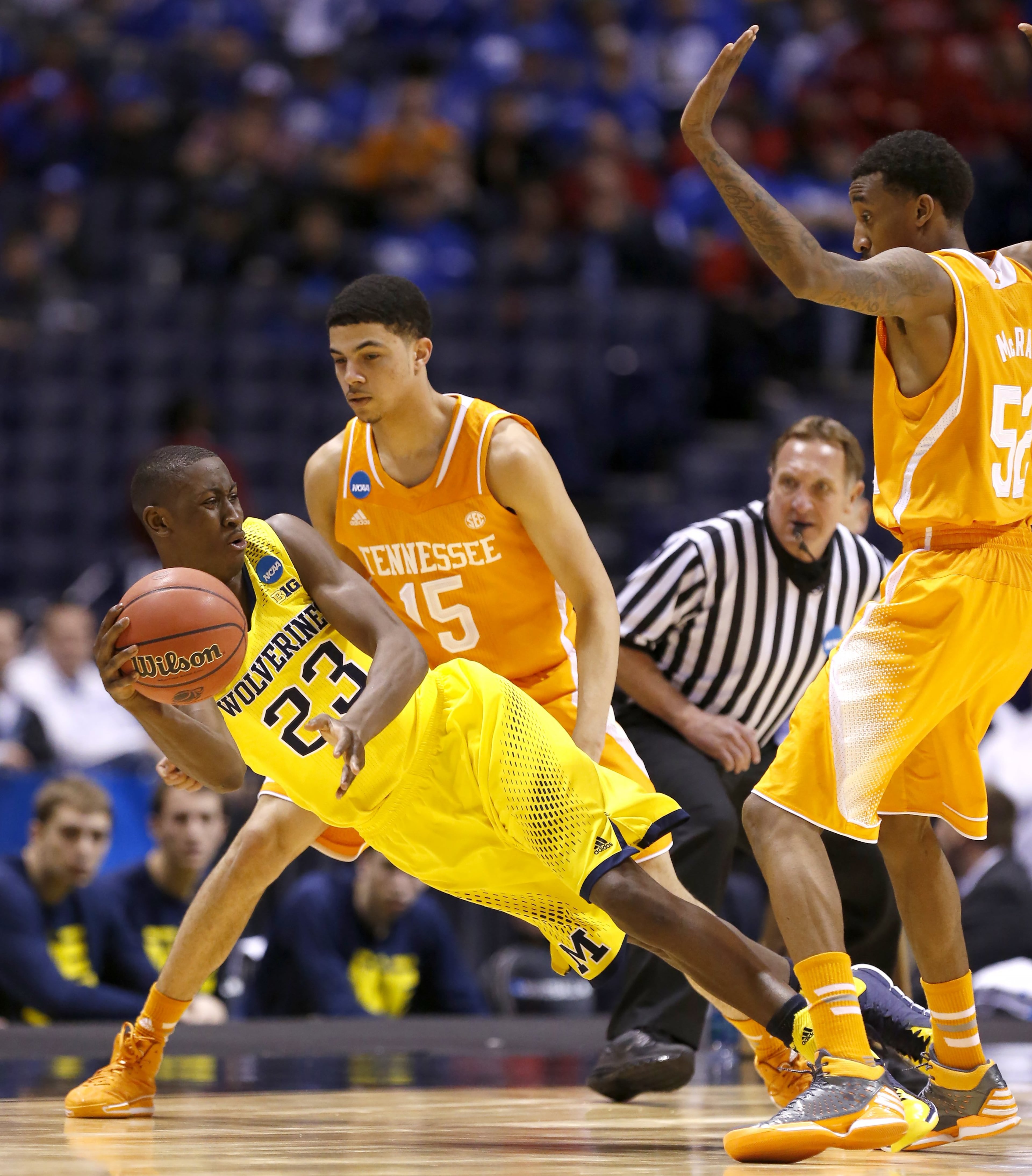 Michigan Wolverines guard Caris LeVert (23) gets rid of the ball under pressure from Tennessee Volunteers guard Darius Thompson (15). Tennessee lost to Michigan 73-71 in the Midwest Regional Friday, Mar. 28, 2014, in Indianapolis.