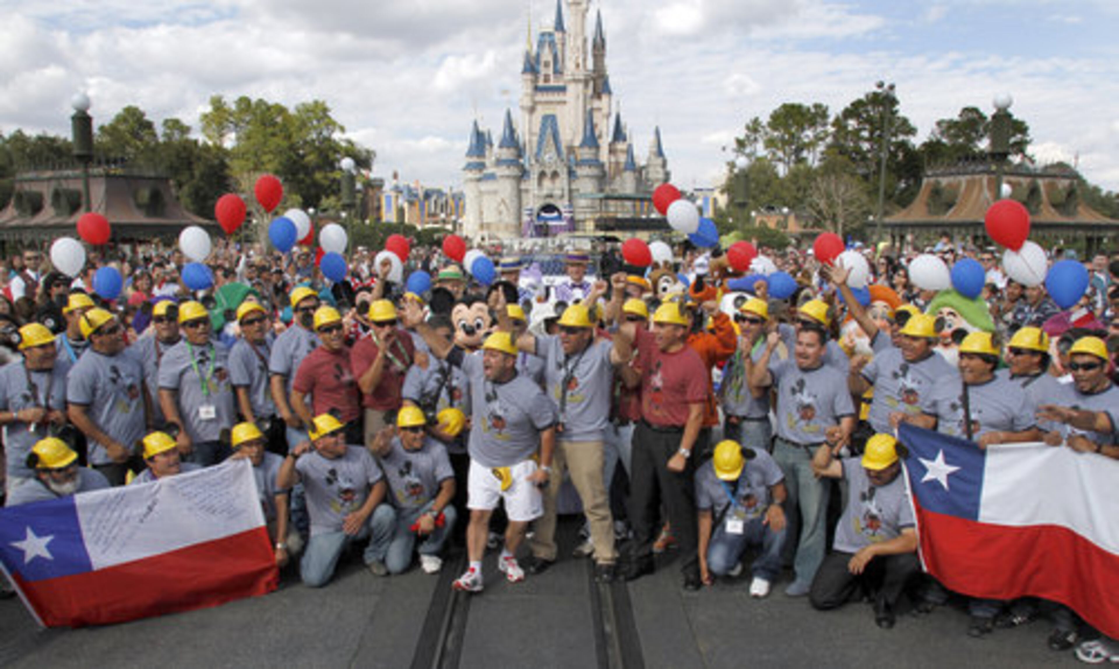 A group of Chilean miners, who were rescued after 69 days underground last year, pose in front of the Magic Kingdom Castle as the miners, their families and some of their rescuers visit Walt Disney World in Orlando, Fla.