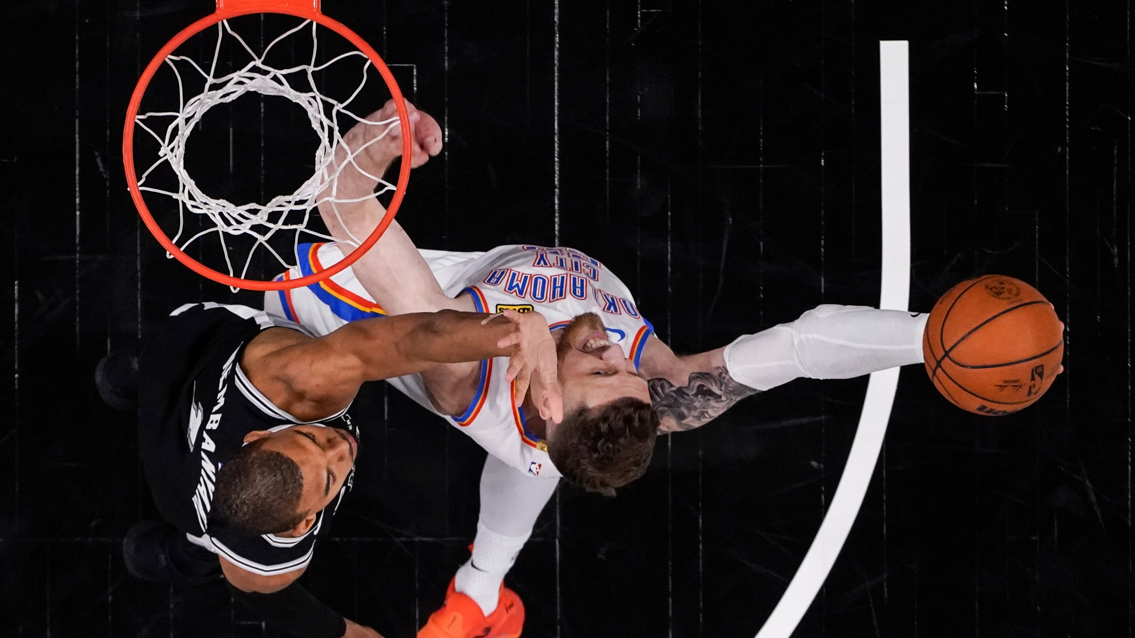 Oklahoma City Thunder center Isaiah Hartenstein (55) shoots against San Antonio Spurs forward Victor Wembanyama (1) in the second half of Game 6 in the Western Conference finals NBA basketball playoffs series, Thursday, May 28, 2026, in San Antonio. (AP Photo/David J. Phillip)